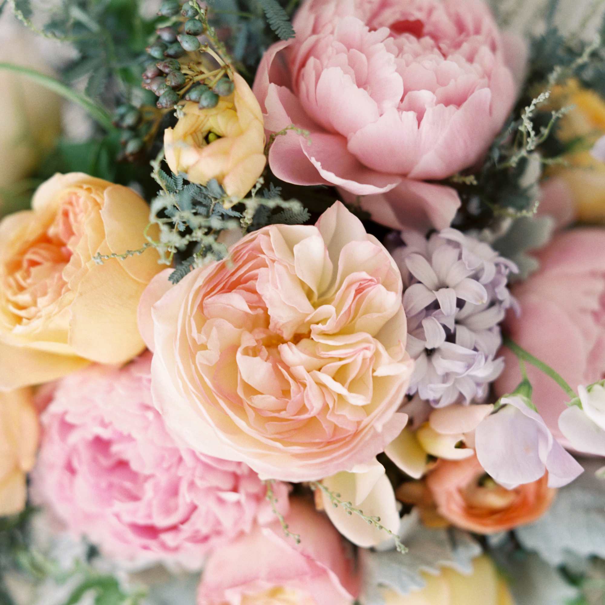 Floral arrangement in springy hues (i.e. pink, lavender, purple, yellow, white, cream