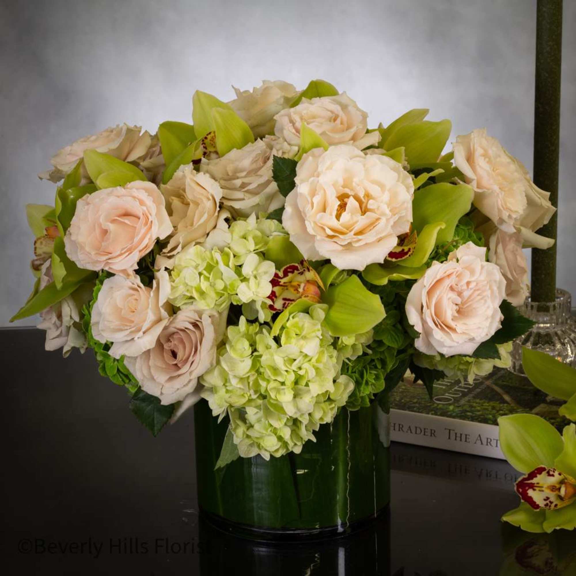 24 Champagne roses accompanied by Green cymbidium orchids and verdant floral arrangements