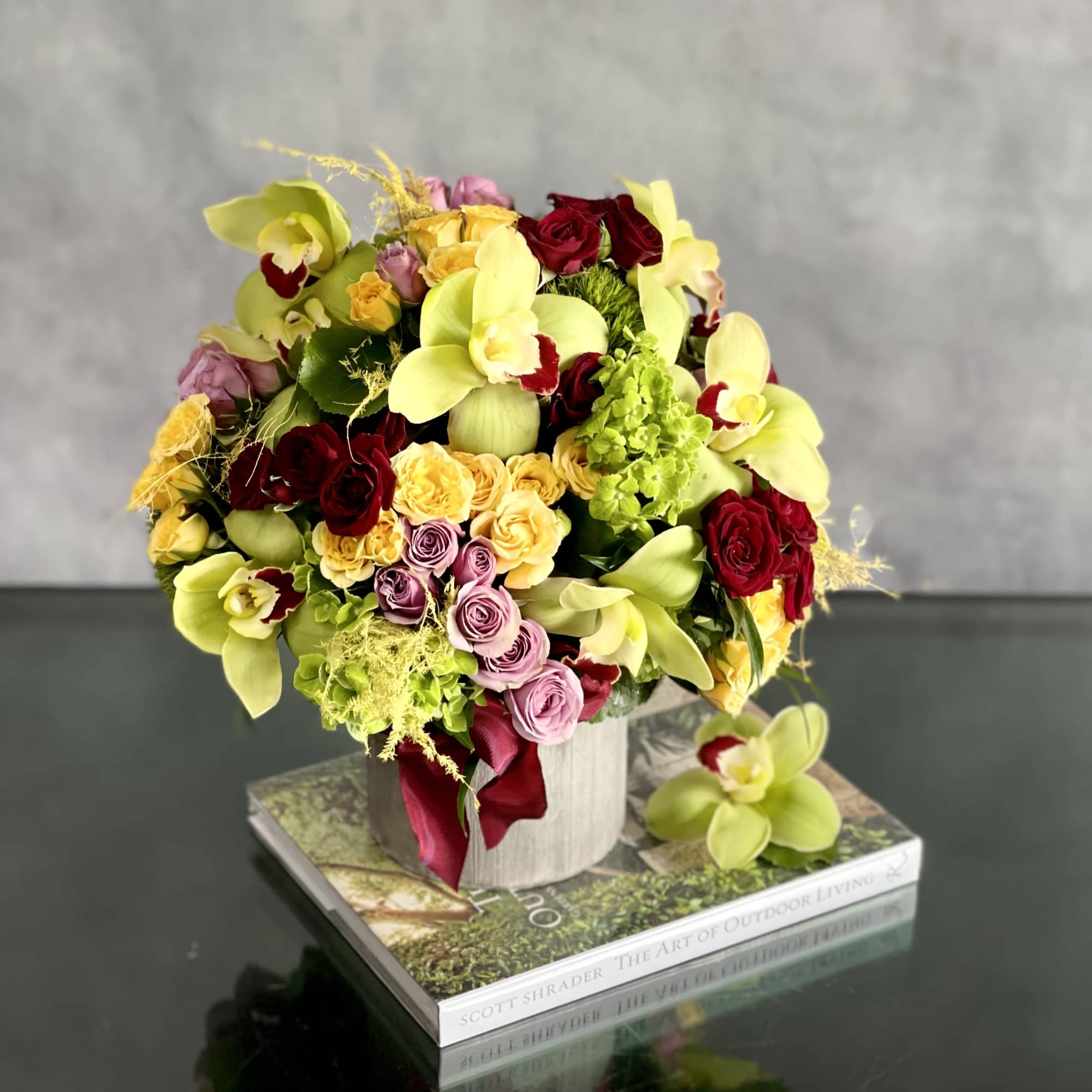 An amazing rounded bouquet of 12 vibrant green cymbidium , red, yellow