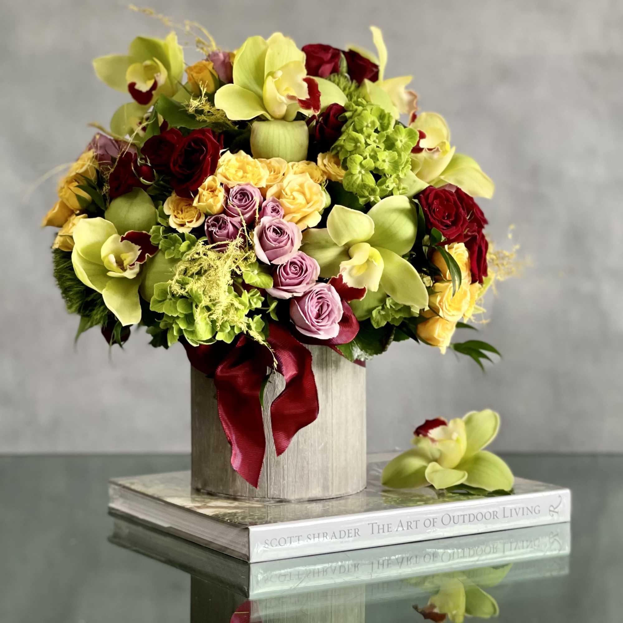 An amazing rounded bouquet of 12 vibrant green cymbidium , red, yellow