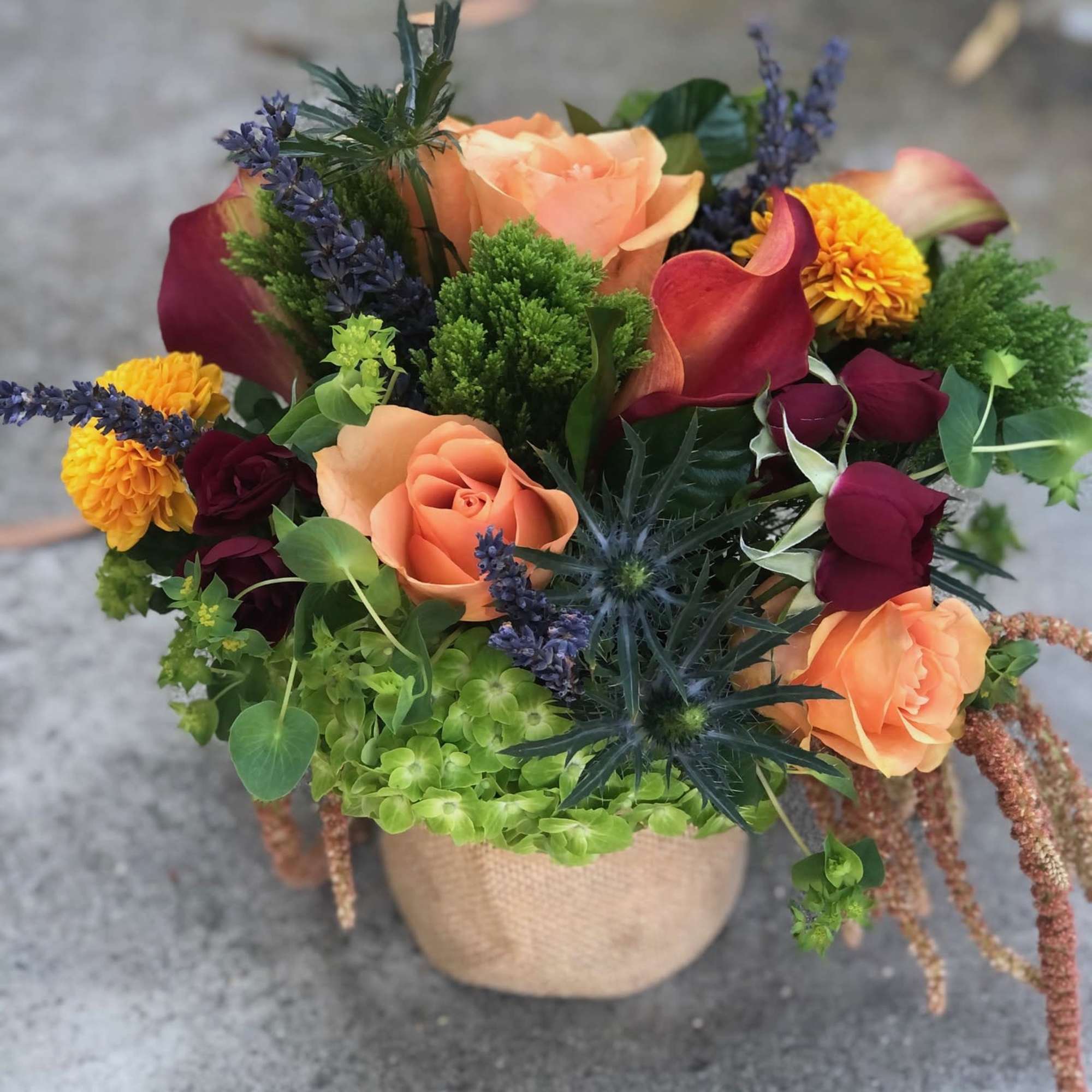 A vibrant and colorful arrangement full of a variety of flowers and