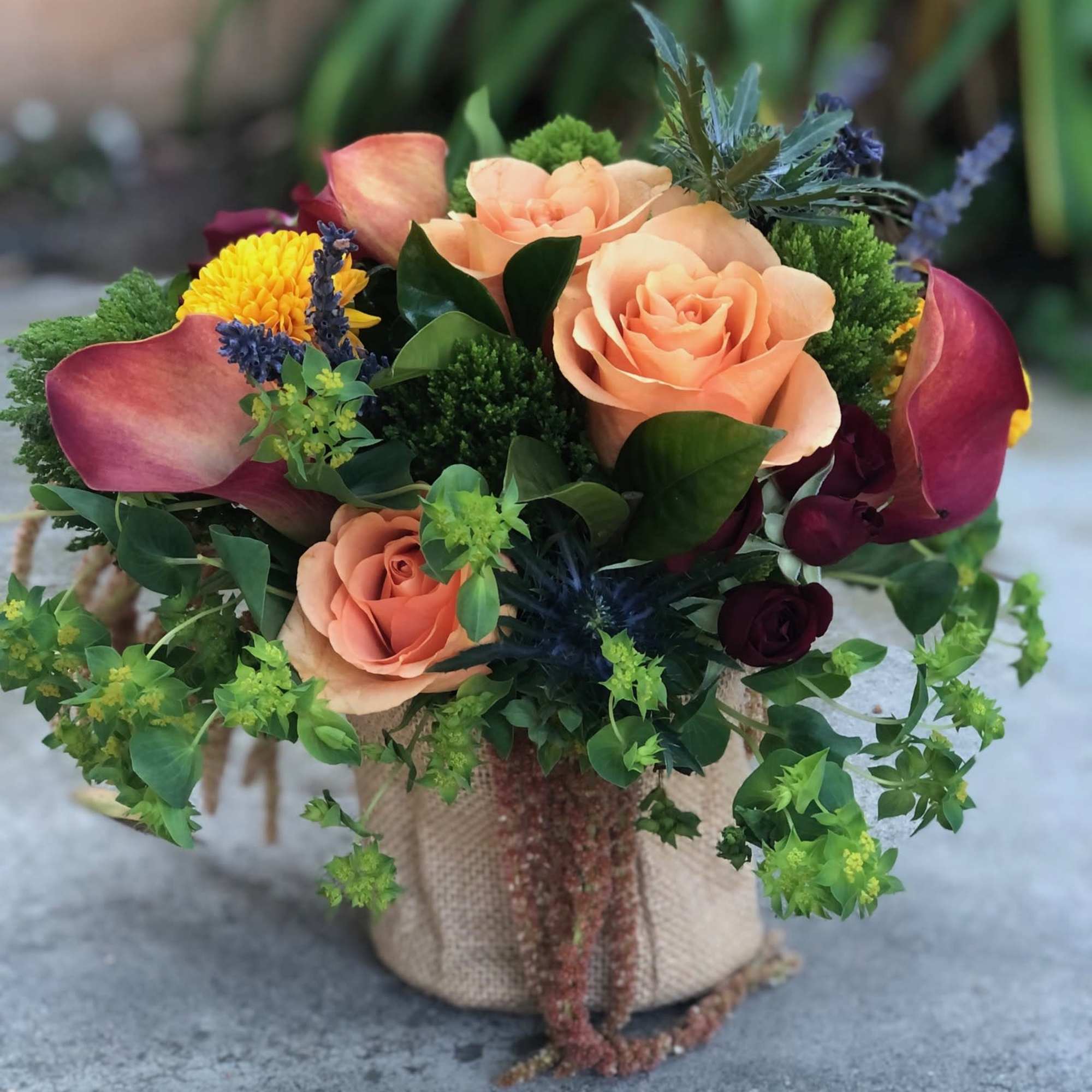 A vibrant and colorful arrangement full of a variety of flowers and