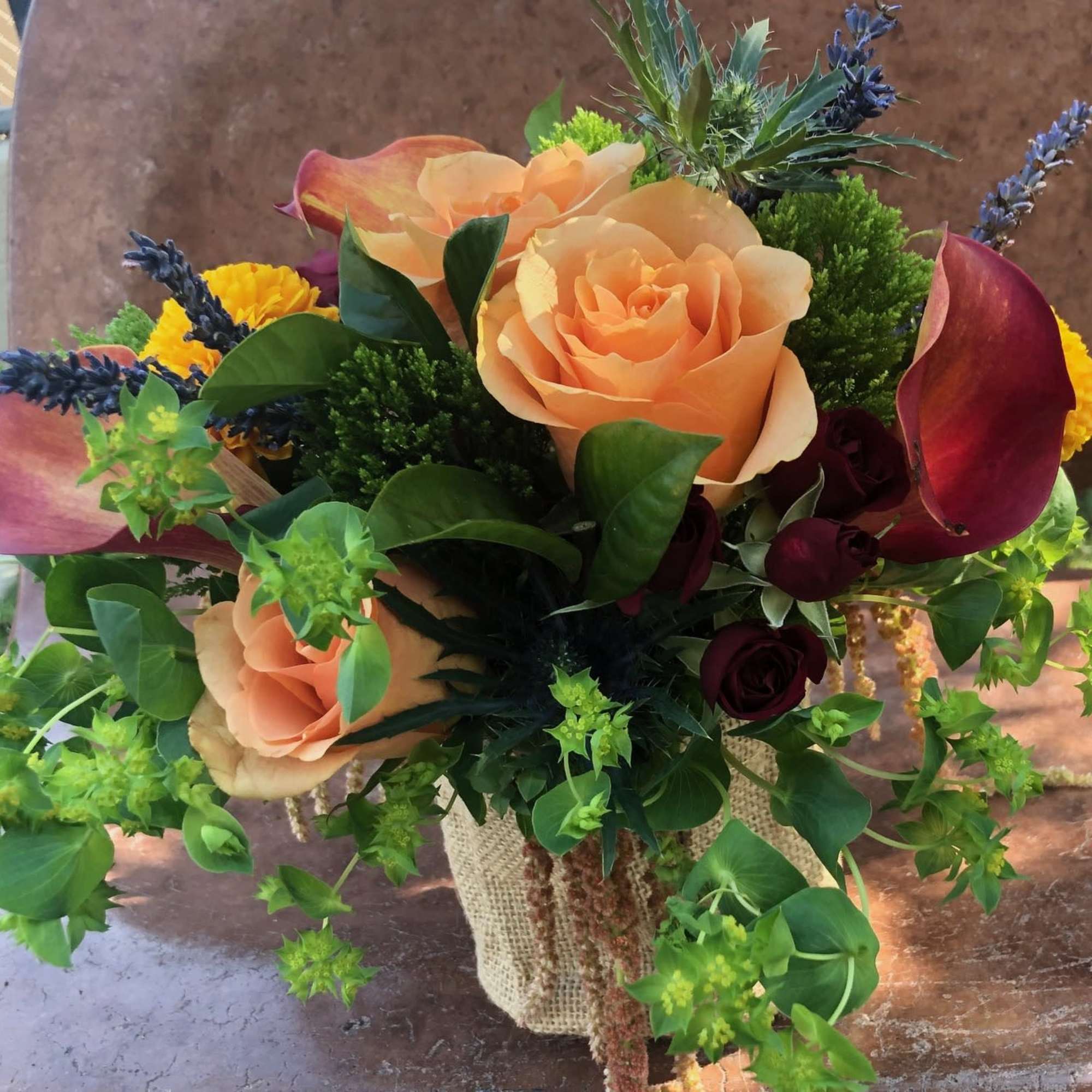 A vibrant and colorful arrangement full of a variety of flowers and