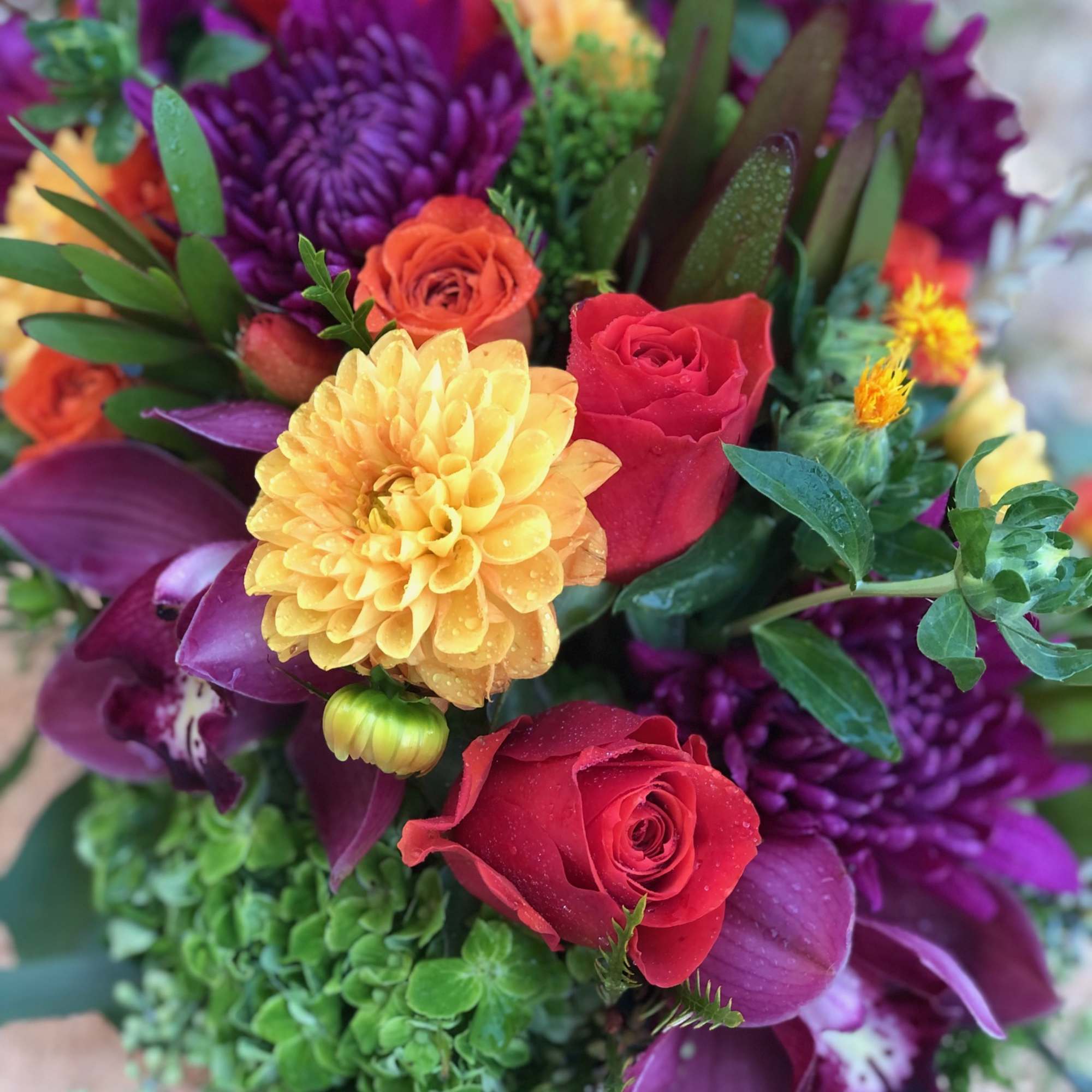 Vibrant fall blooms in an oblong birch box. Featuring Dahlias, Roses, Orchid