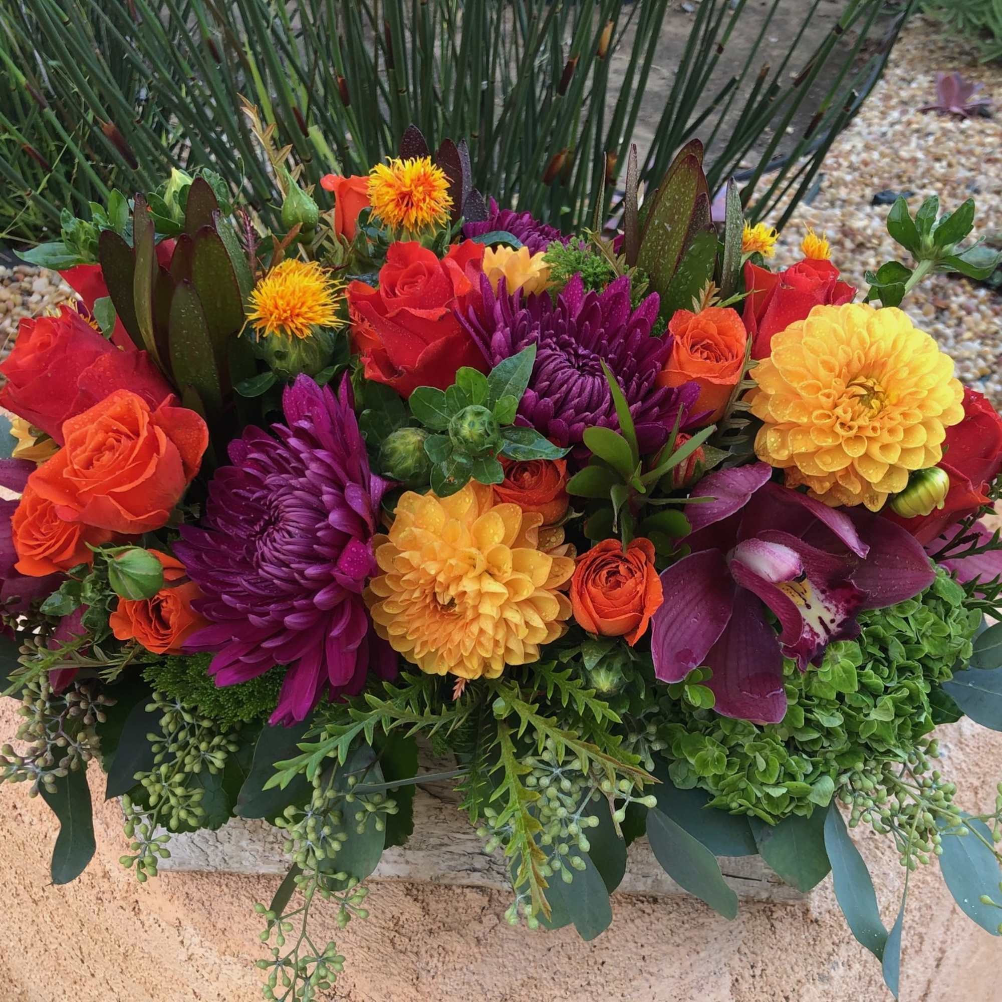 Vibrant fall blooms in an oblong birch box. Featuring Dahlias, Roses, Orchid