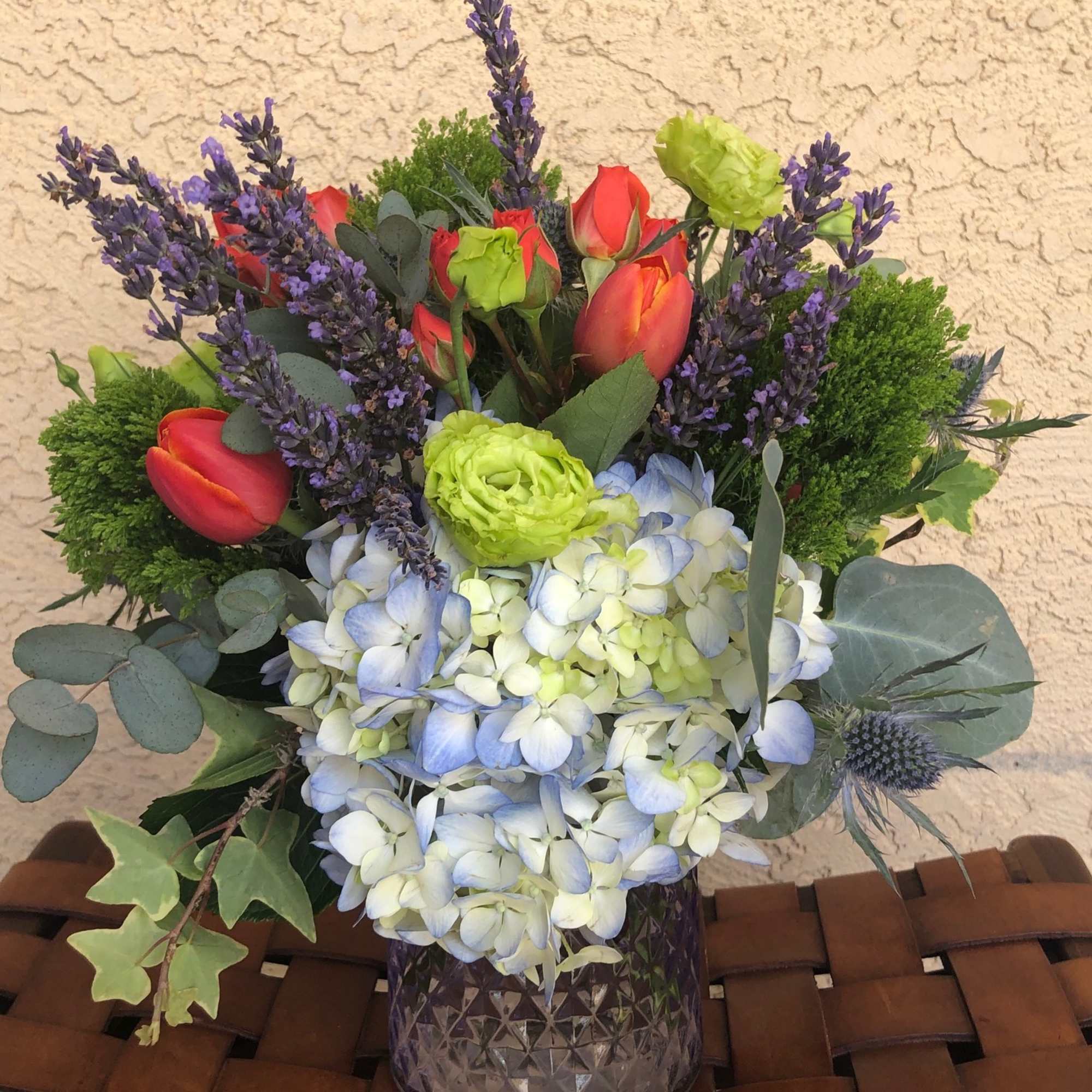 Stunning arrangement of Blue Hydrangea, Vermillion Red Spray Roses and Tulips, Fresh