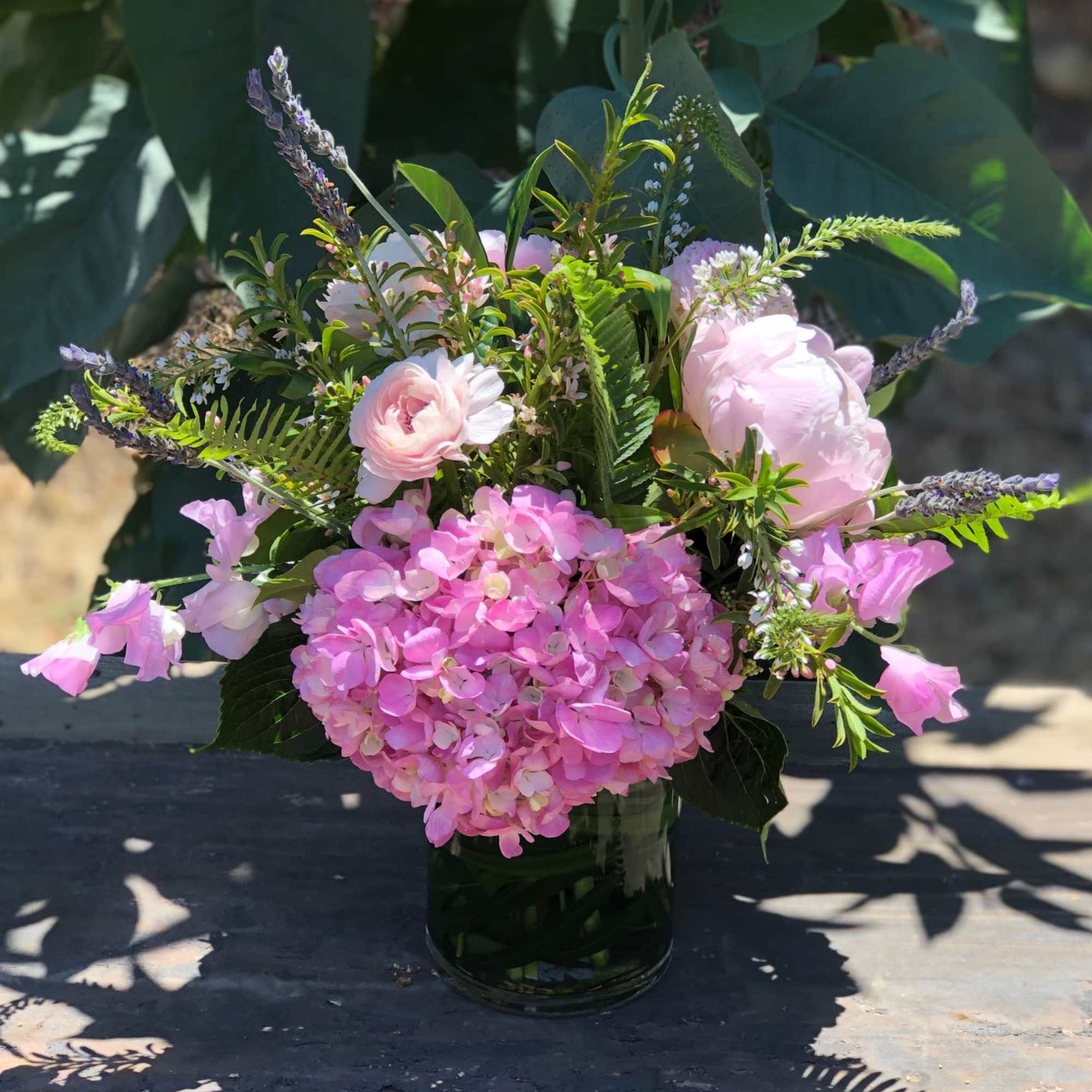A collection of mixed pink blooms with a lavender accent and fresh