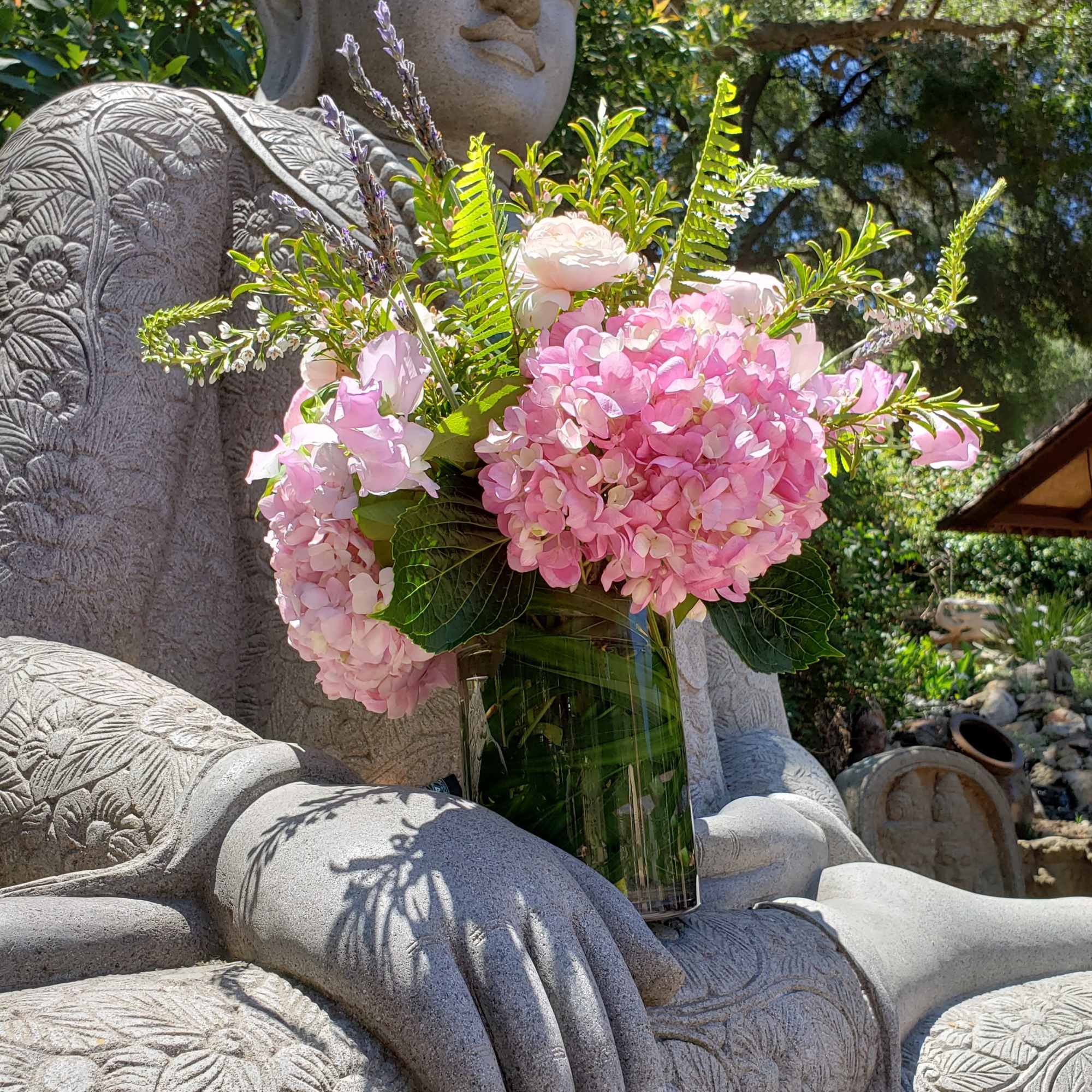 A collection of mixed pink blooms with a lavender accent and fresh