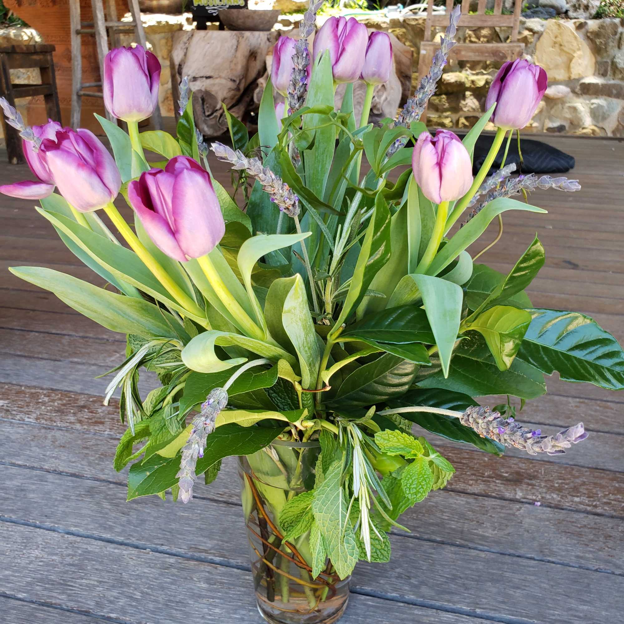 An arrangement of just tulips and fresh lavender with lush greens such