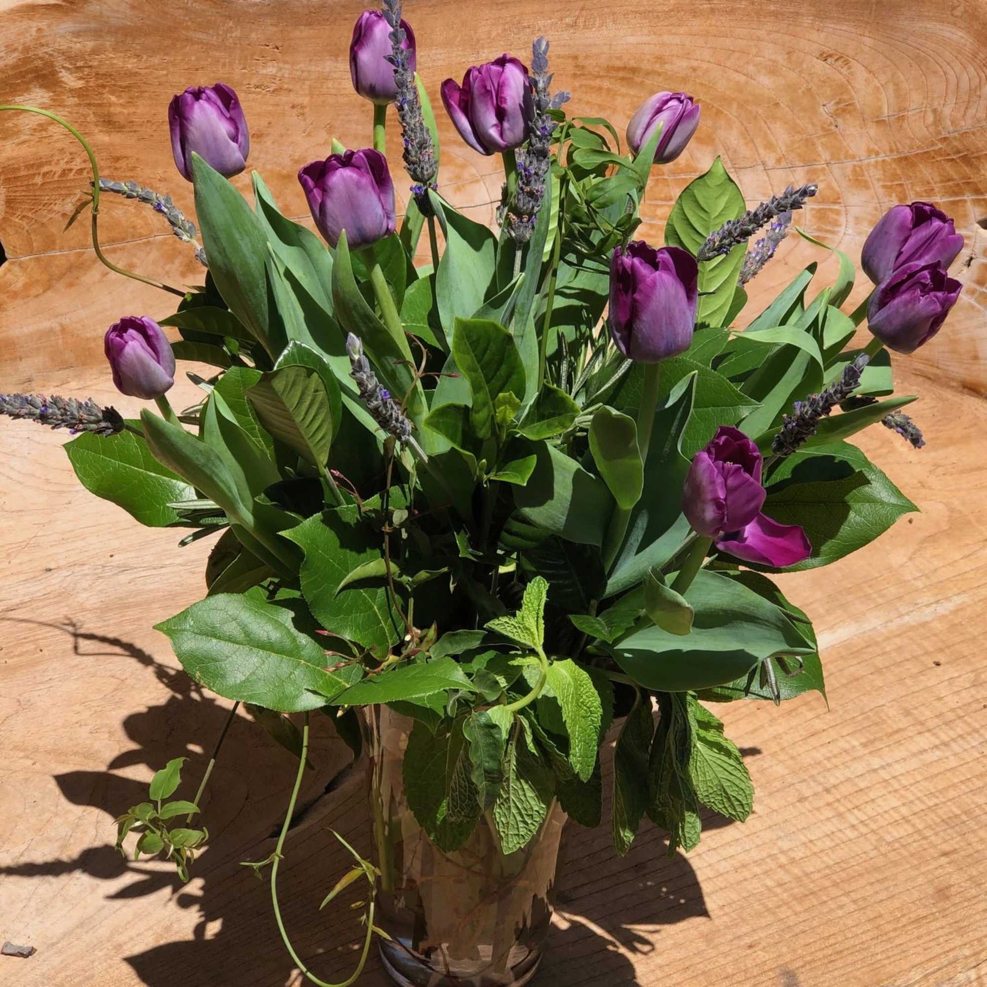 An arrangement of just tulips and fresh lavender with lush greens such
