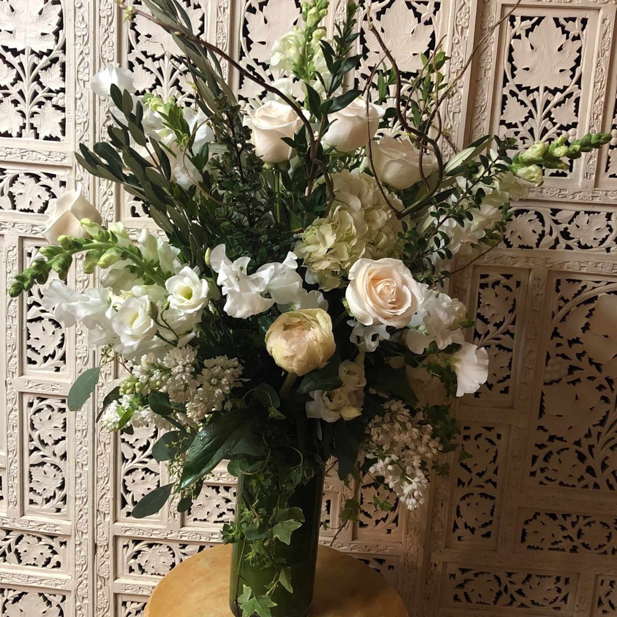 Gorgeous, tall arrangement with an assortment of white and cream garden flowers