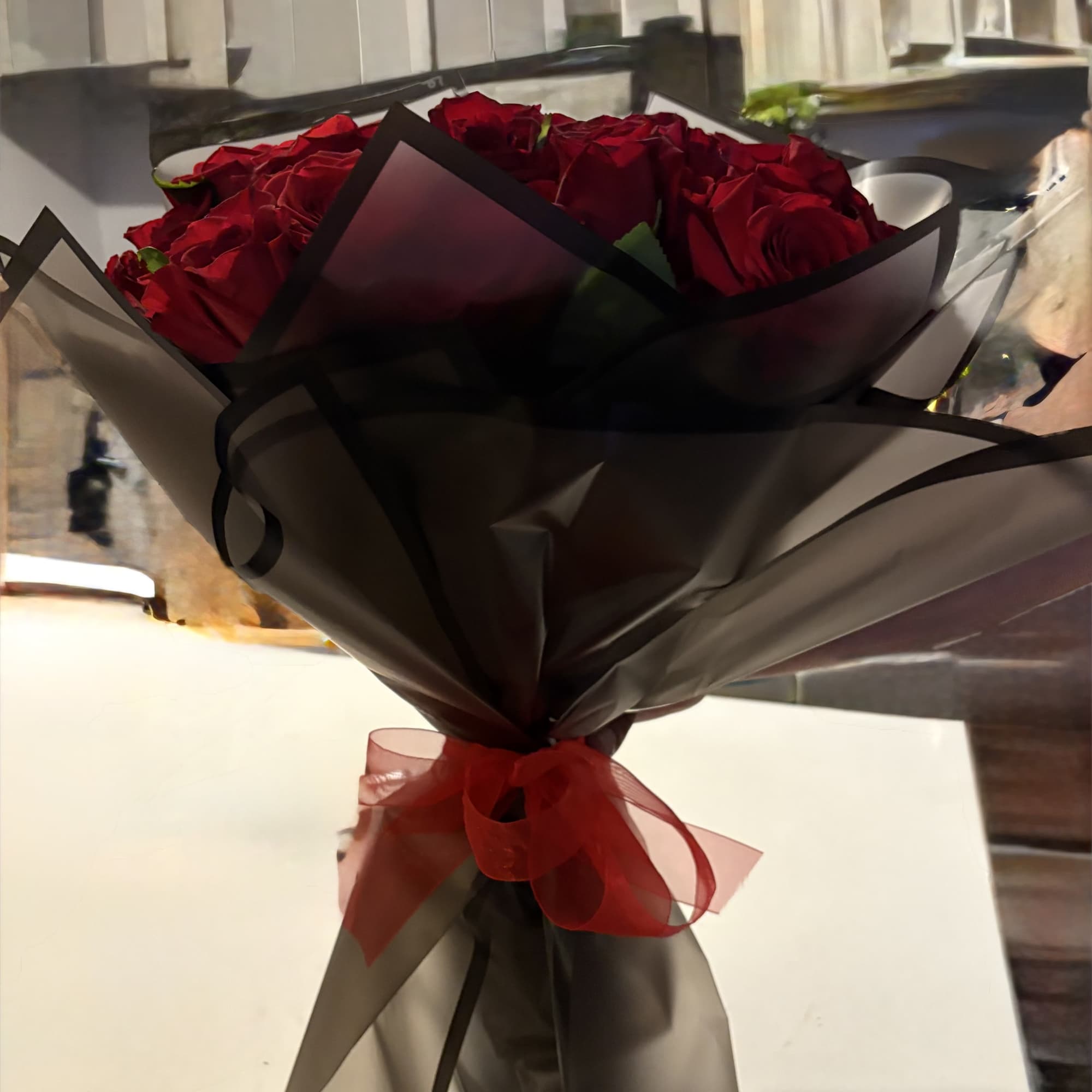 48 Hand tied roses wrapped in an elegant black craft paper tide