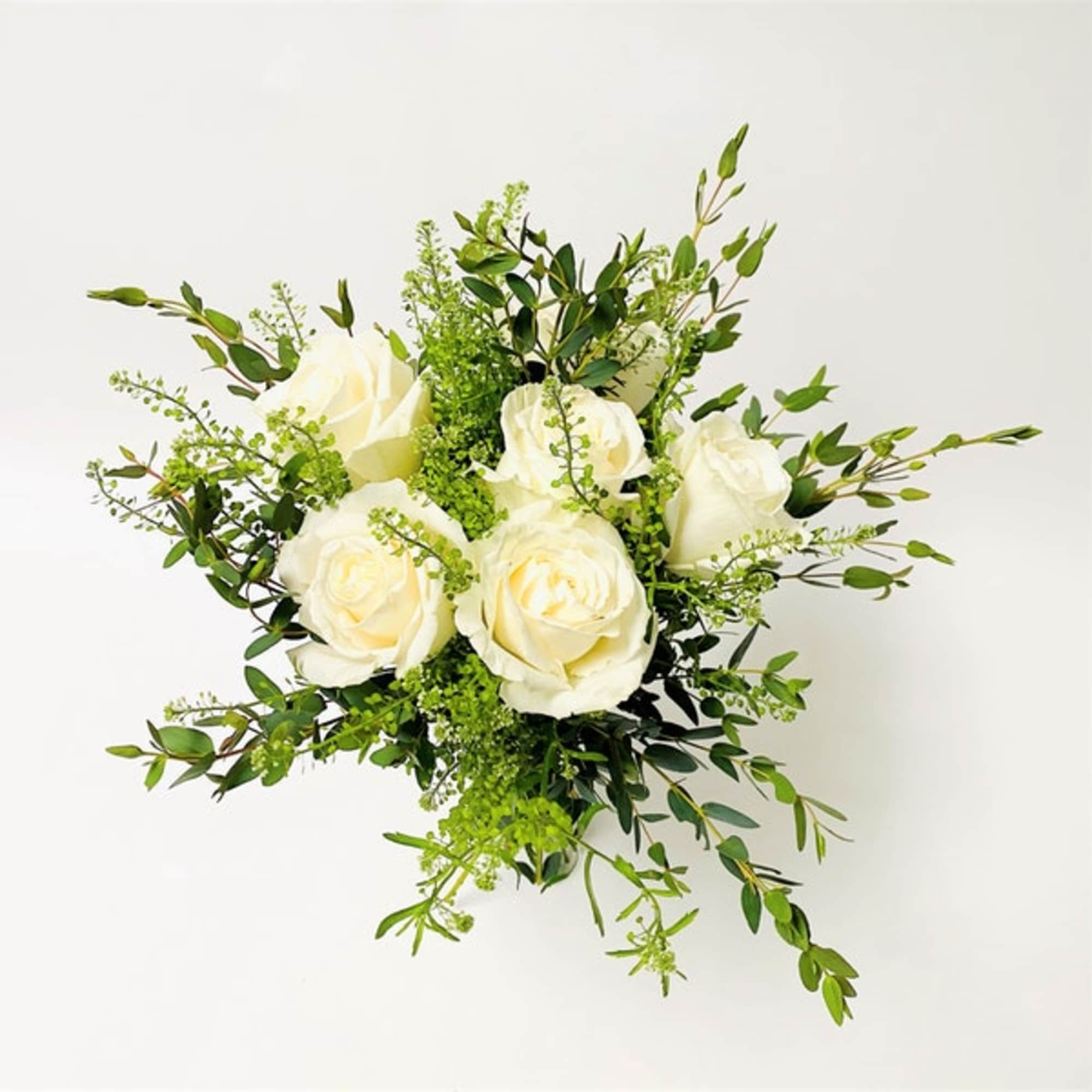 Simple white hand-tied bouquet featuring white roses. 