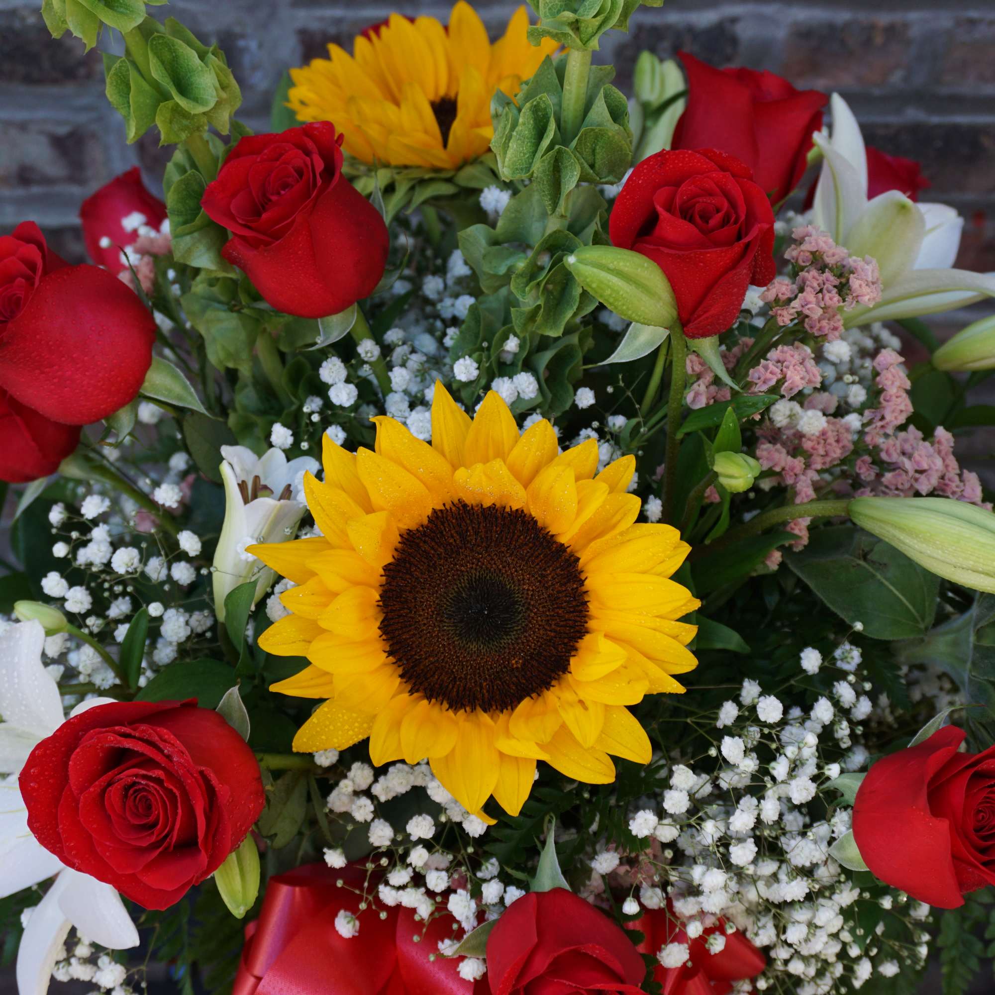 One dozen red roses, sunflowers, lilies, bells of ireland. One dozen red roses, sunflowers, lilies, bells of ireland.