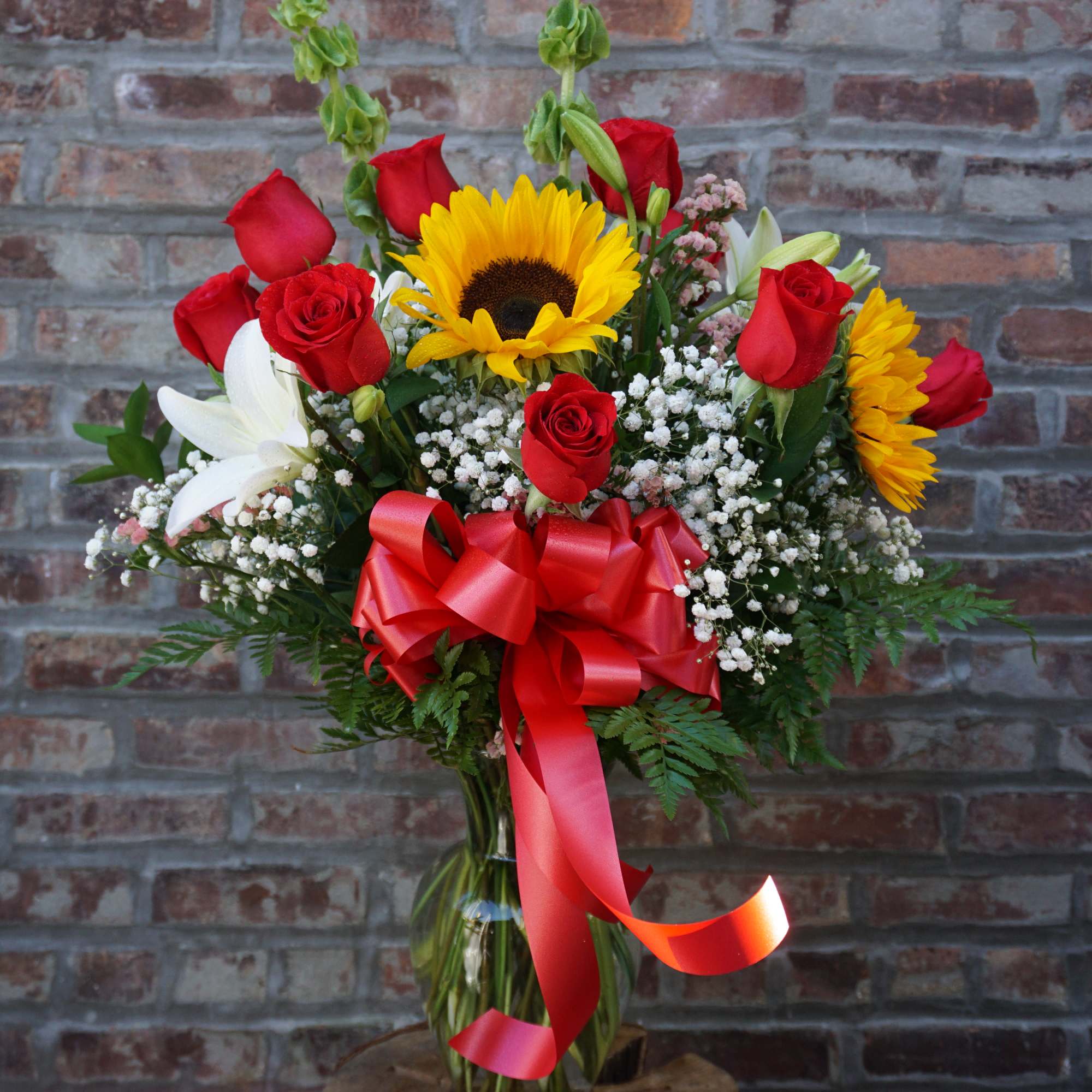 One dozen red roses, sunflowers, lilies, bells of ireland. One dozen red roses, sunflowers, lilies, bells of ireland.
