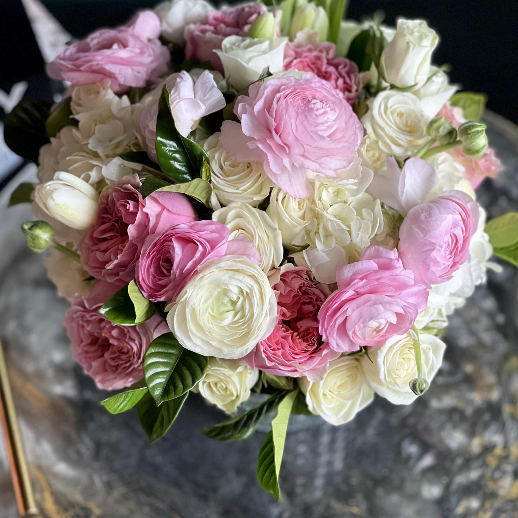 Vase flower design with white roses, ranunculus, spray roses, tulips, garden roses