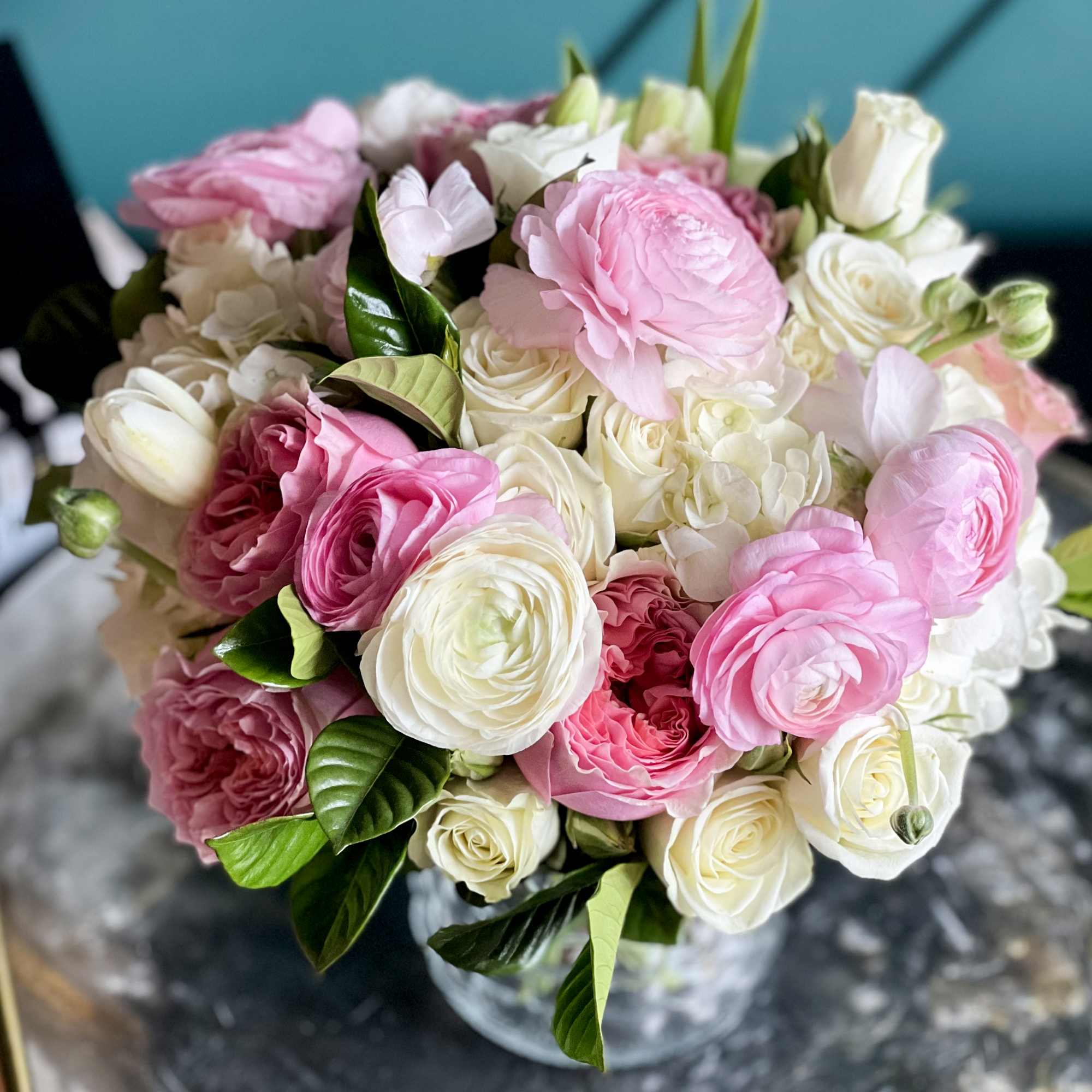 Vase flower design with white roses, ranunculus, spray roses, tulips, garden roses