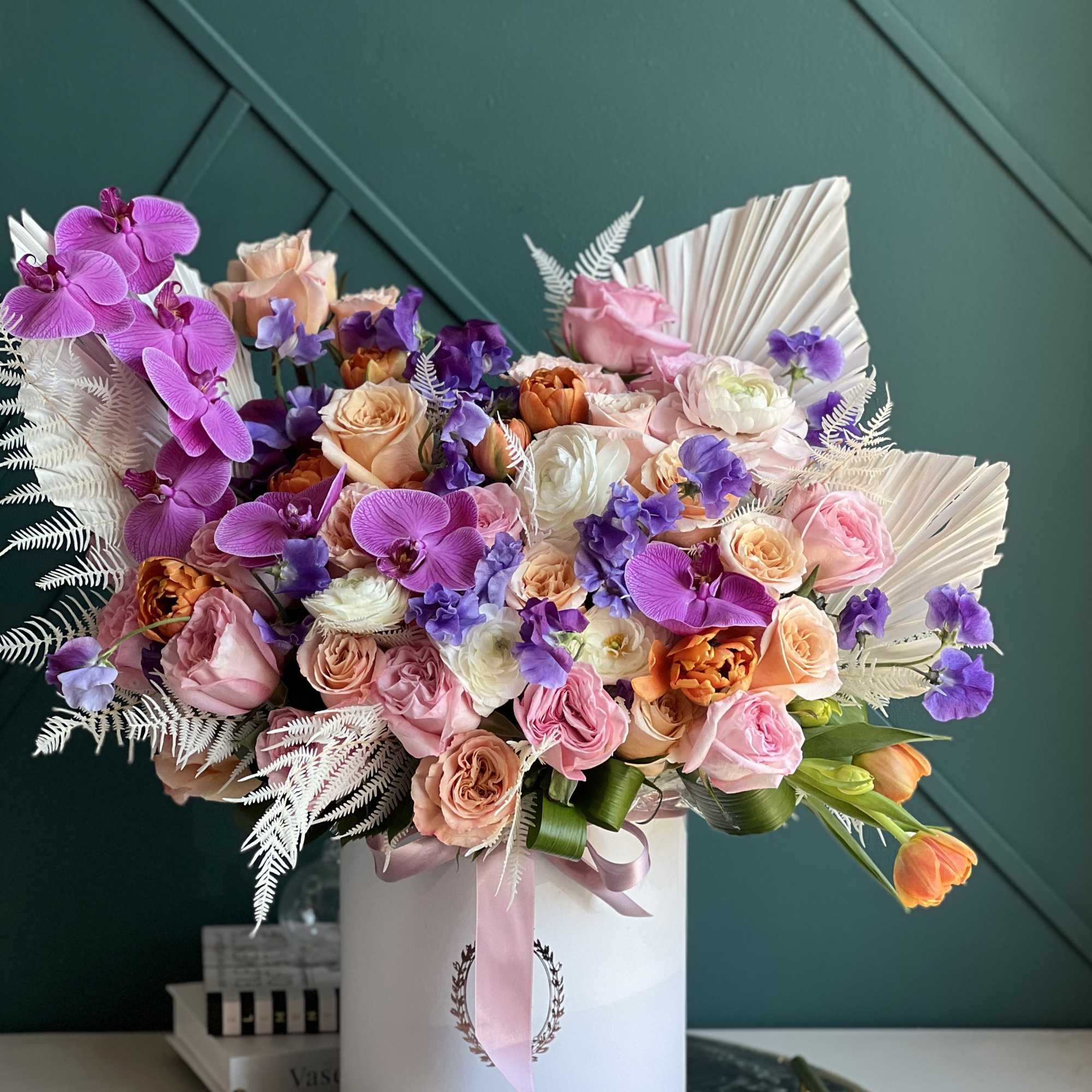 Luxurious arrangement full with flowers.

Includes roses, garden roses, tulips, ranunculus, phalaenopsis orchids