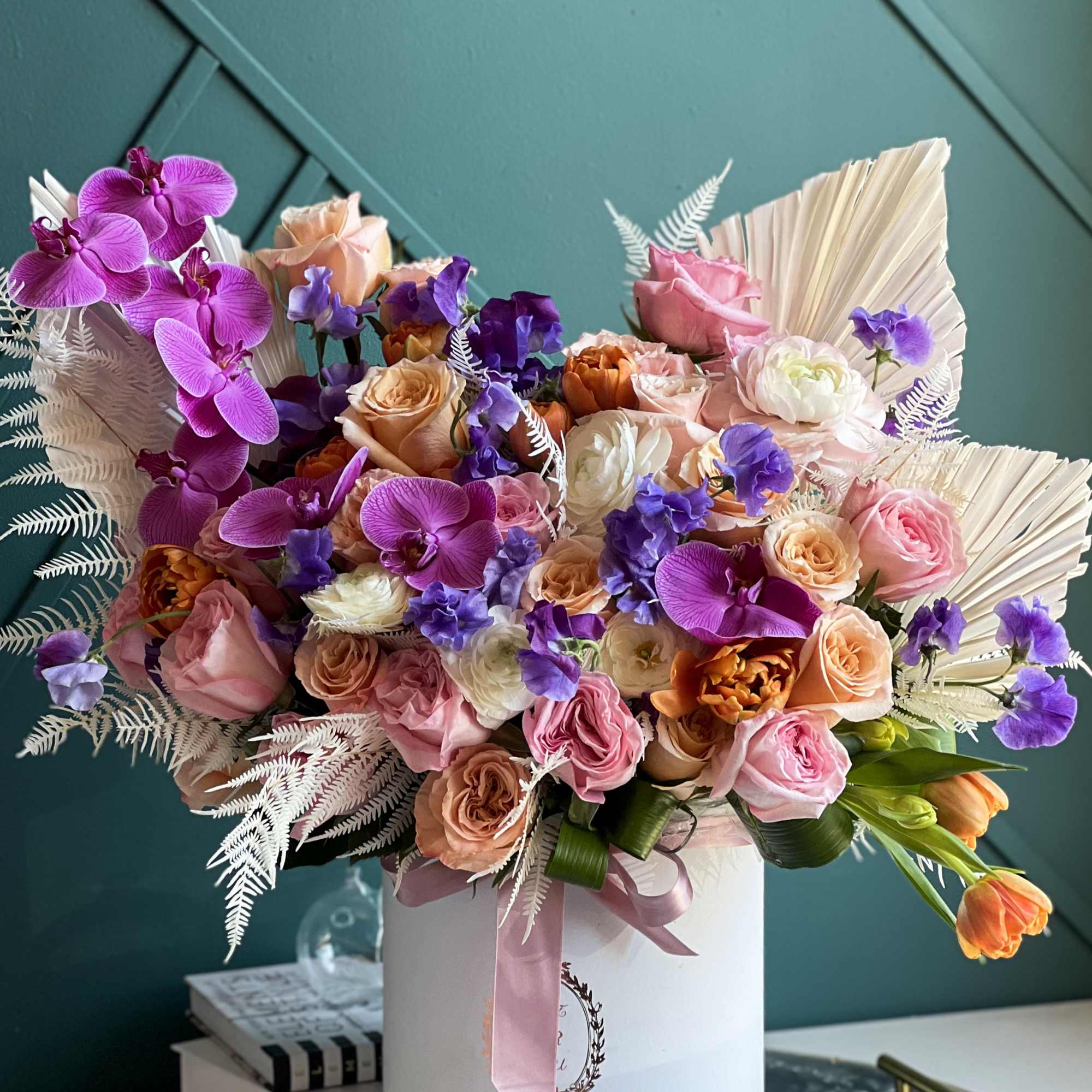 Luxurious arrangement full with flowers.

Includes roses, garden roses, tulips, ranunculus, phalaenopsis orchids