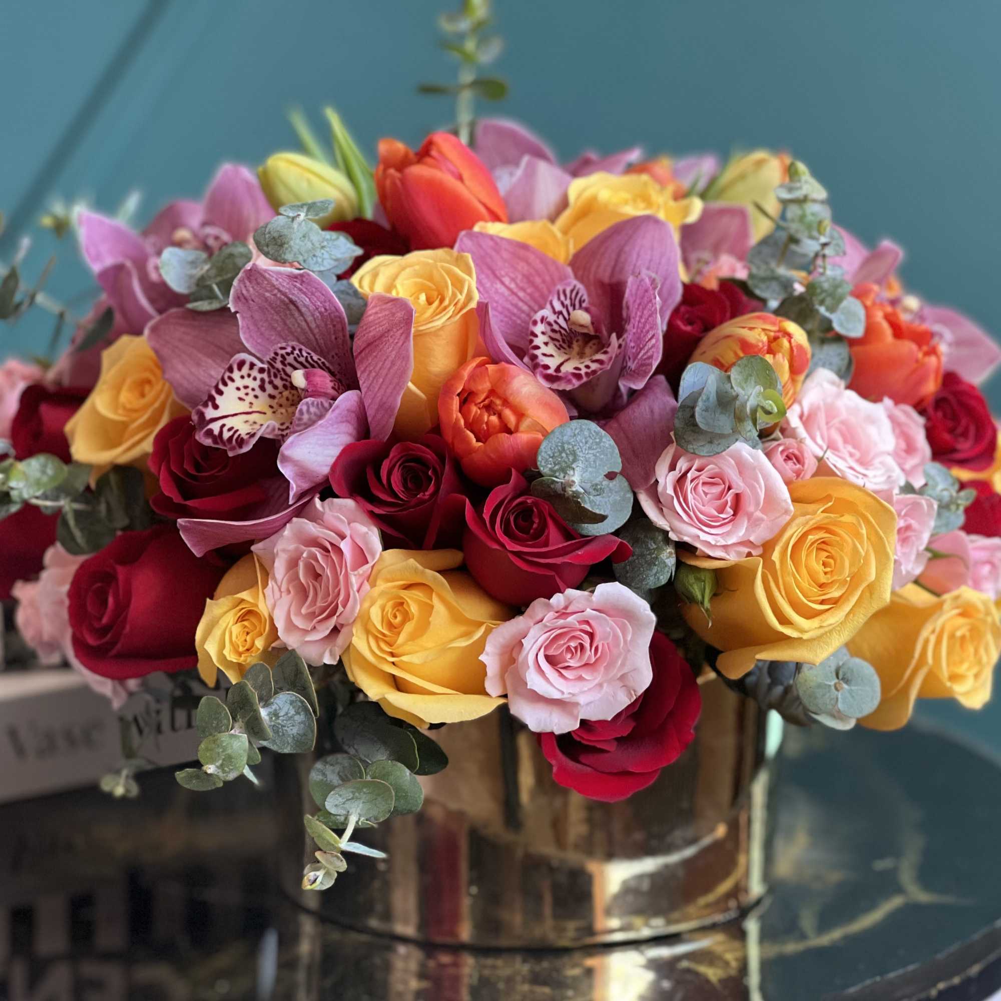 Fresh flower design in gold vase with more than 3 dozen roses