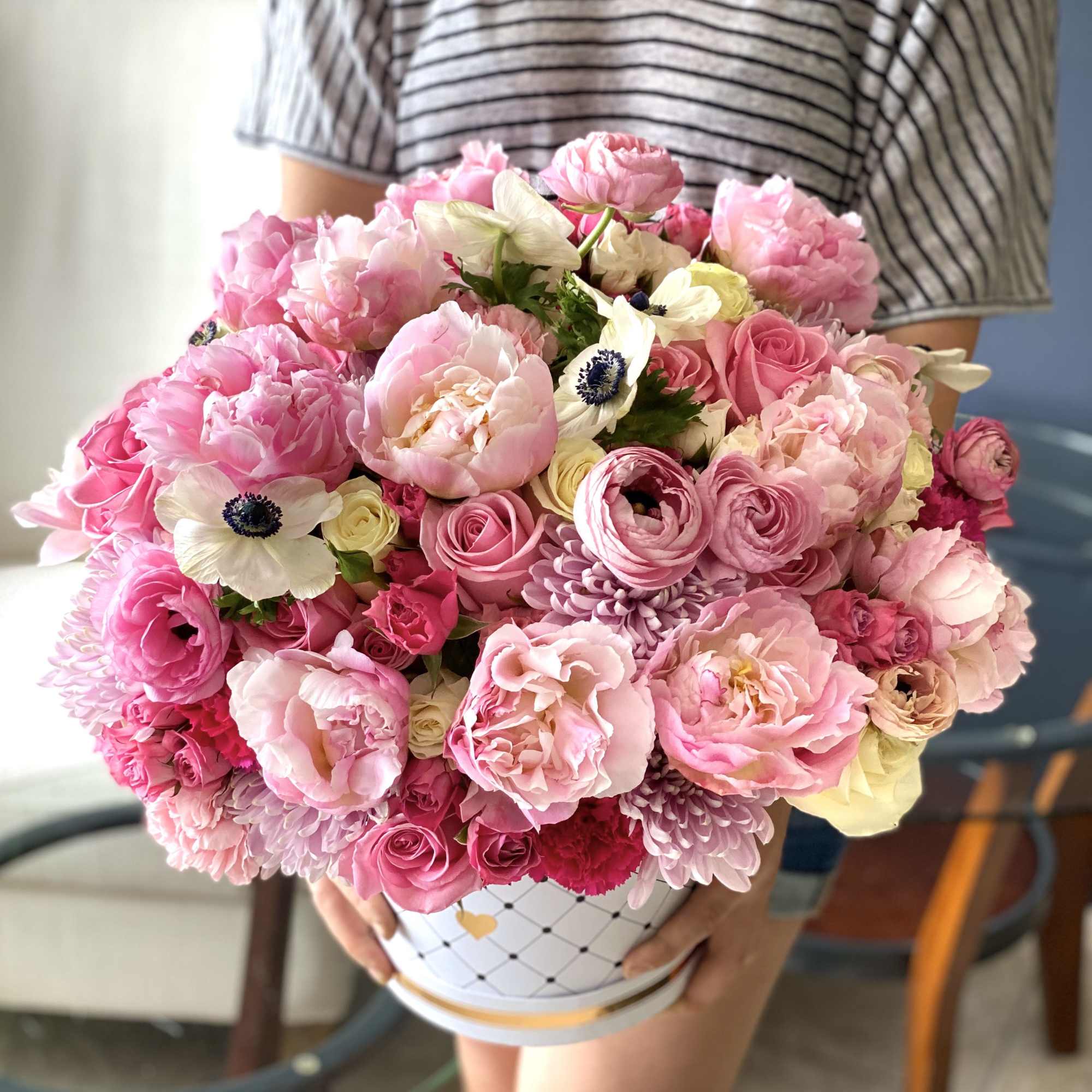 Flower Design in Box with Spring Flowers. Roses, spray roses, ranunculus, anemones