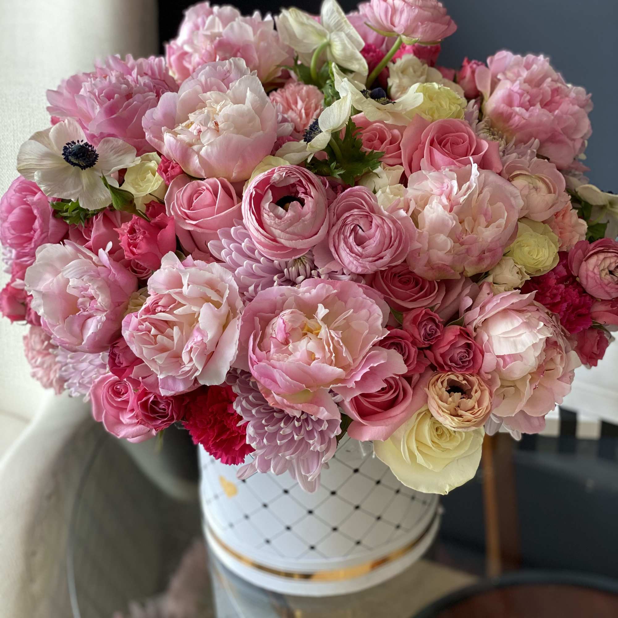Flower Design in Box with Spring Flowers. Roses, spray roses, ranunculus, anemones