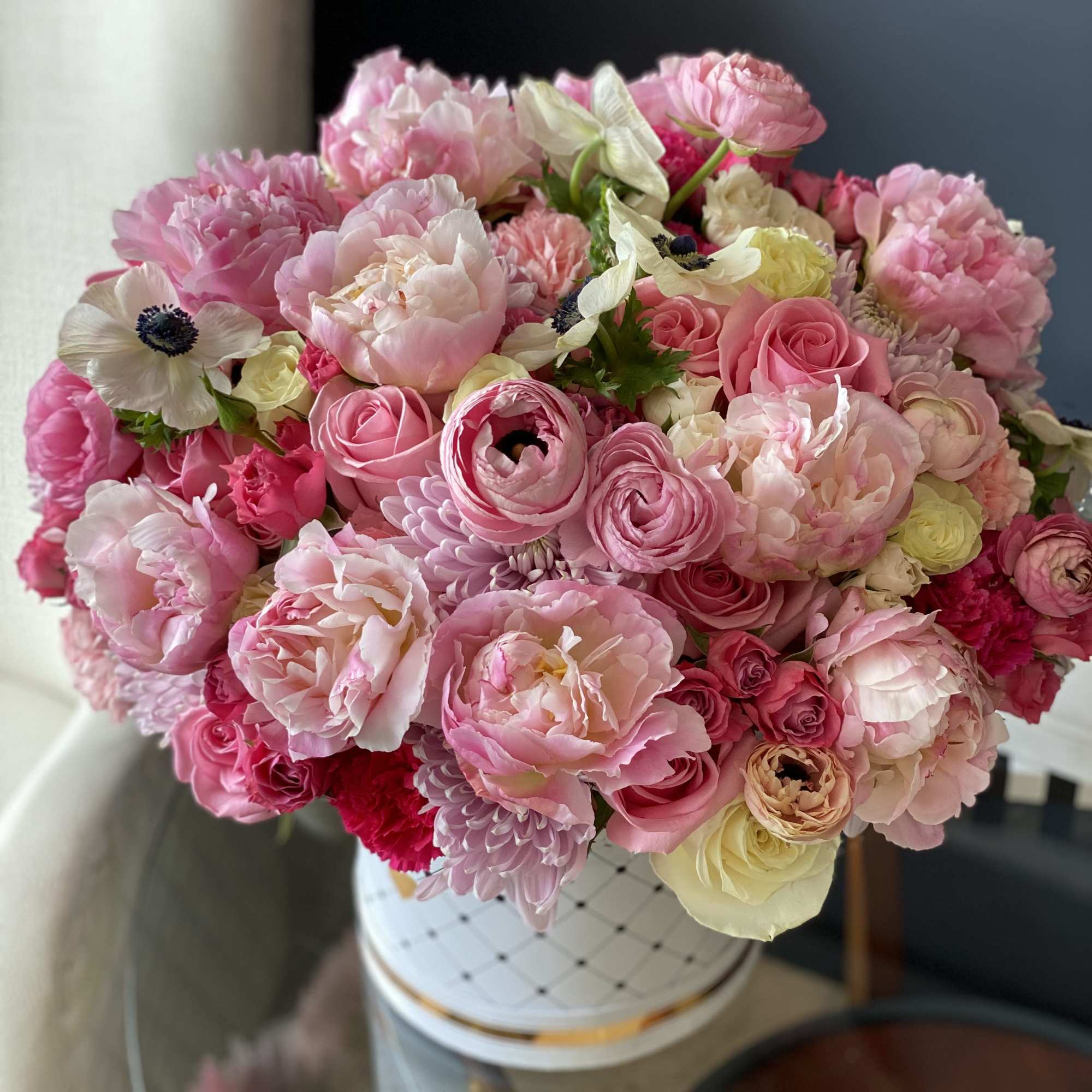 Flower Design in Box with Spring Flowers. Roses, spray roses, ranunculus, anemones