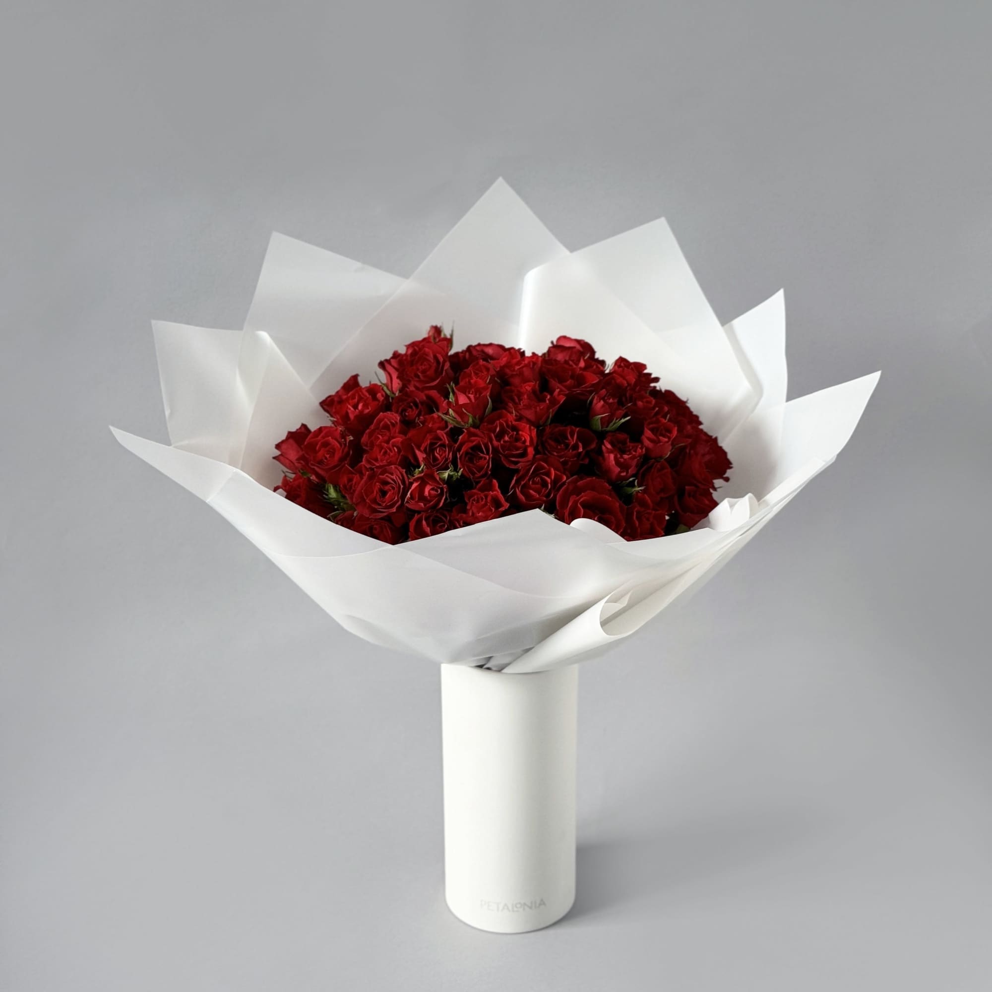 Experience pure elegance with Petalonia&#039;s mini roses&mdash;beautifully arranged in our signature vase