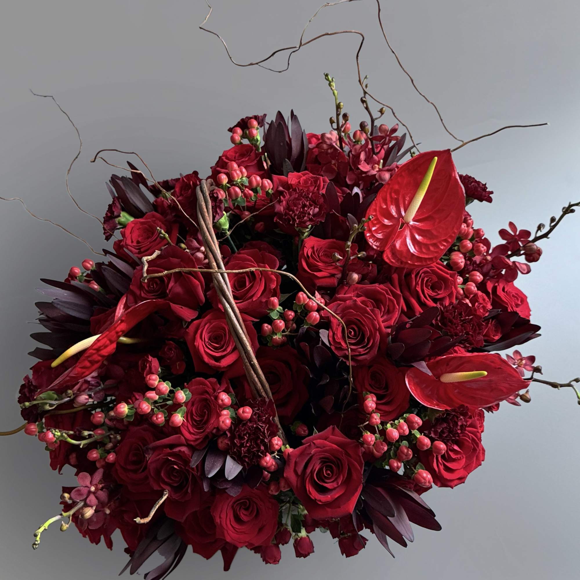 Fall in love with our stunning red flower basket filled with red
