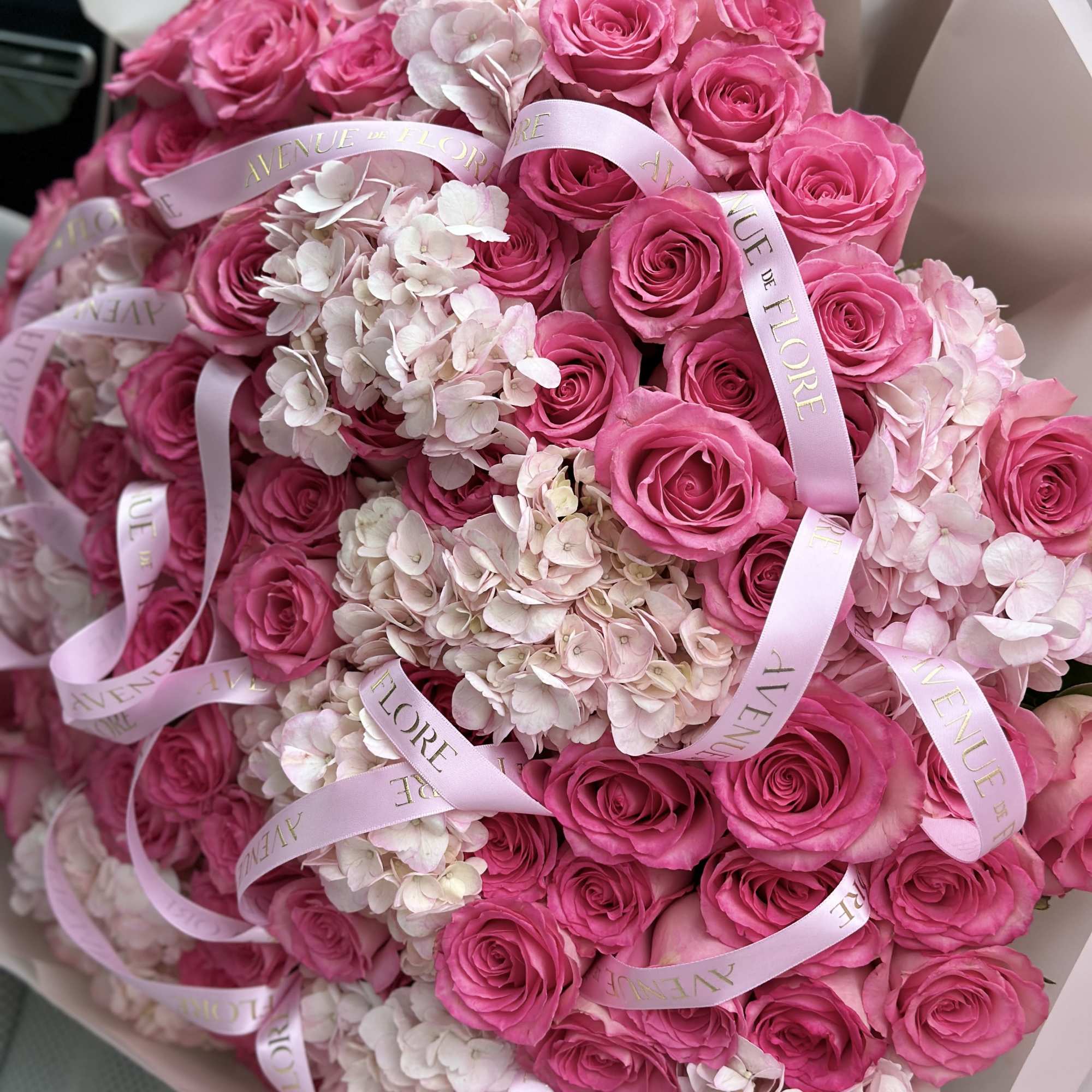 Introducing a stunning arrangement, bursting with soft, romantic blooms. This bouquet is