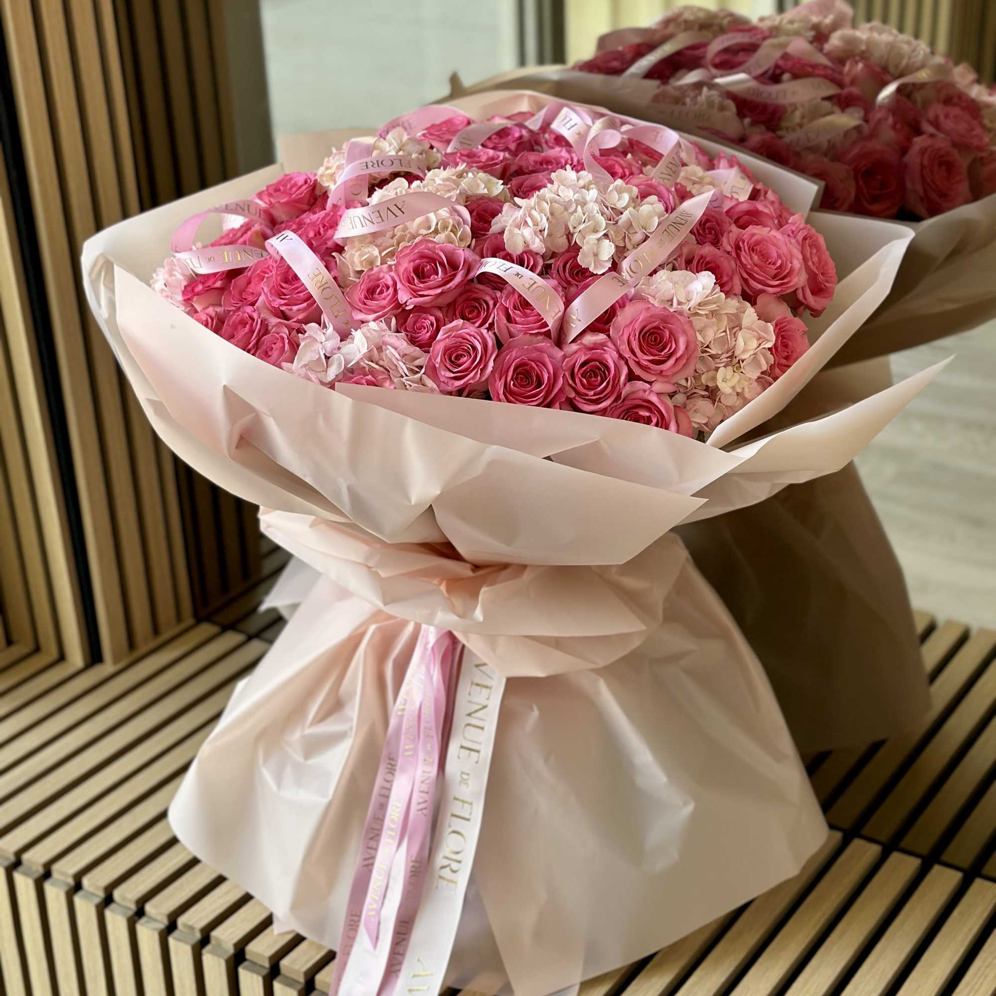 Introducing a stunning arrangement, bursting with soft, romantic blooms. This bouquet is