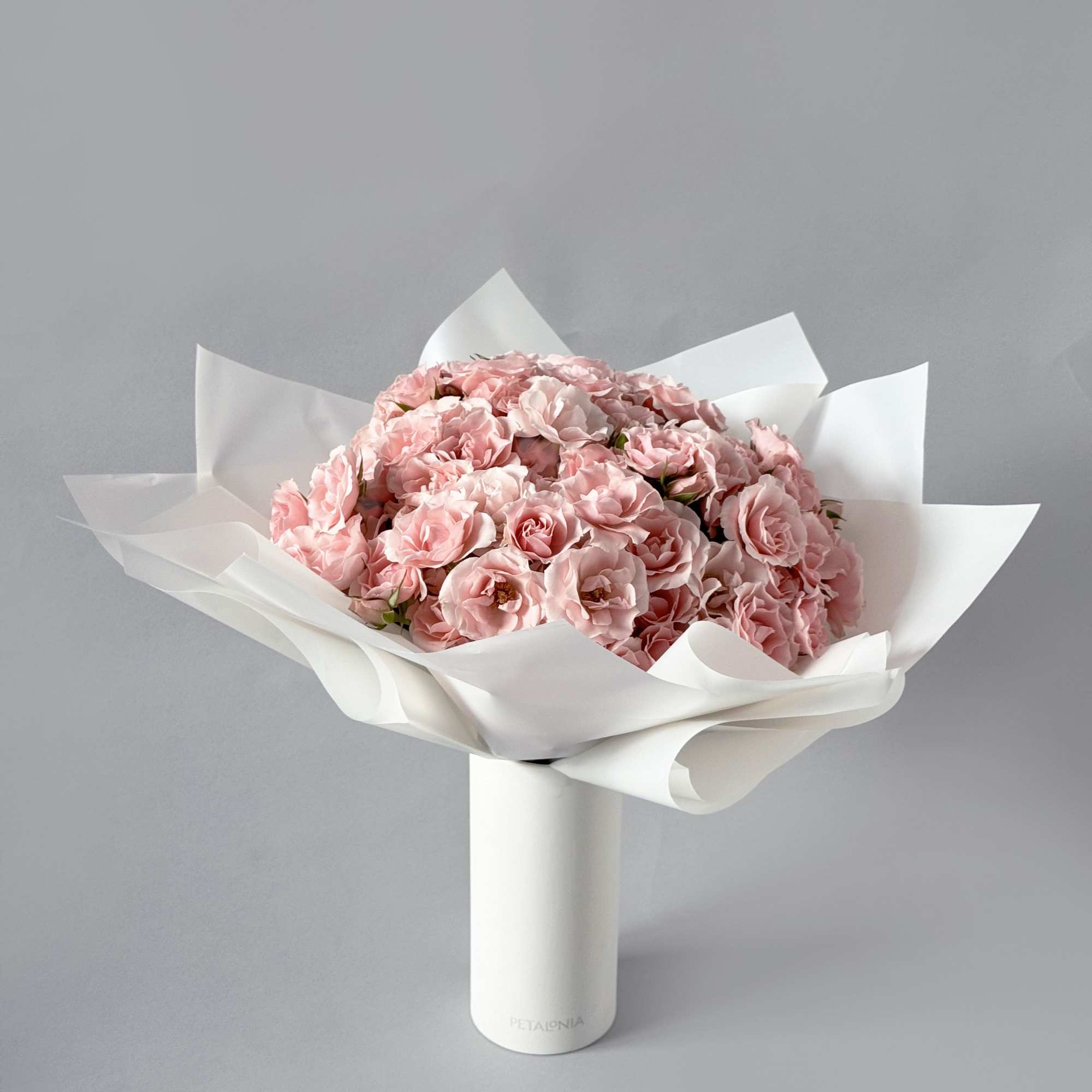 Experience pure elegance with Petalonia&#039;s mini roses&mdash;beautifully arranged in our signature vase