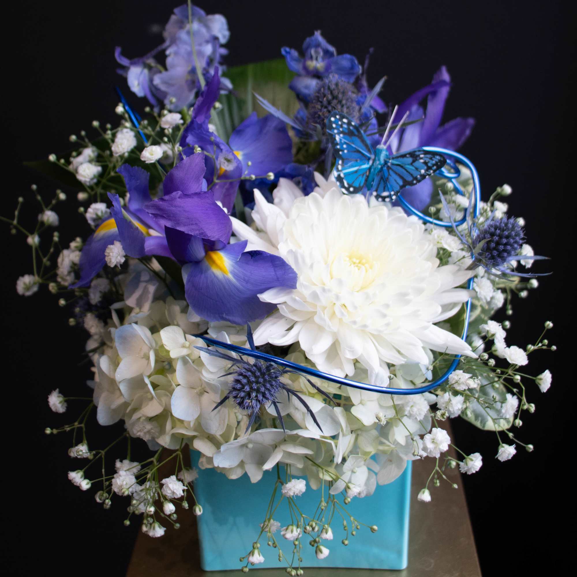 A small sweet arrangement in a robin egg blue vase to help
