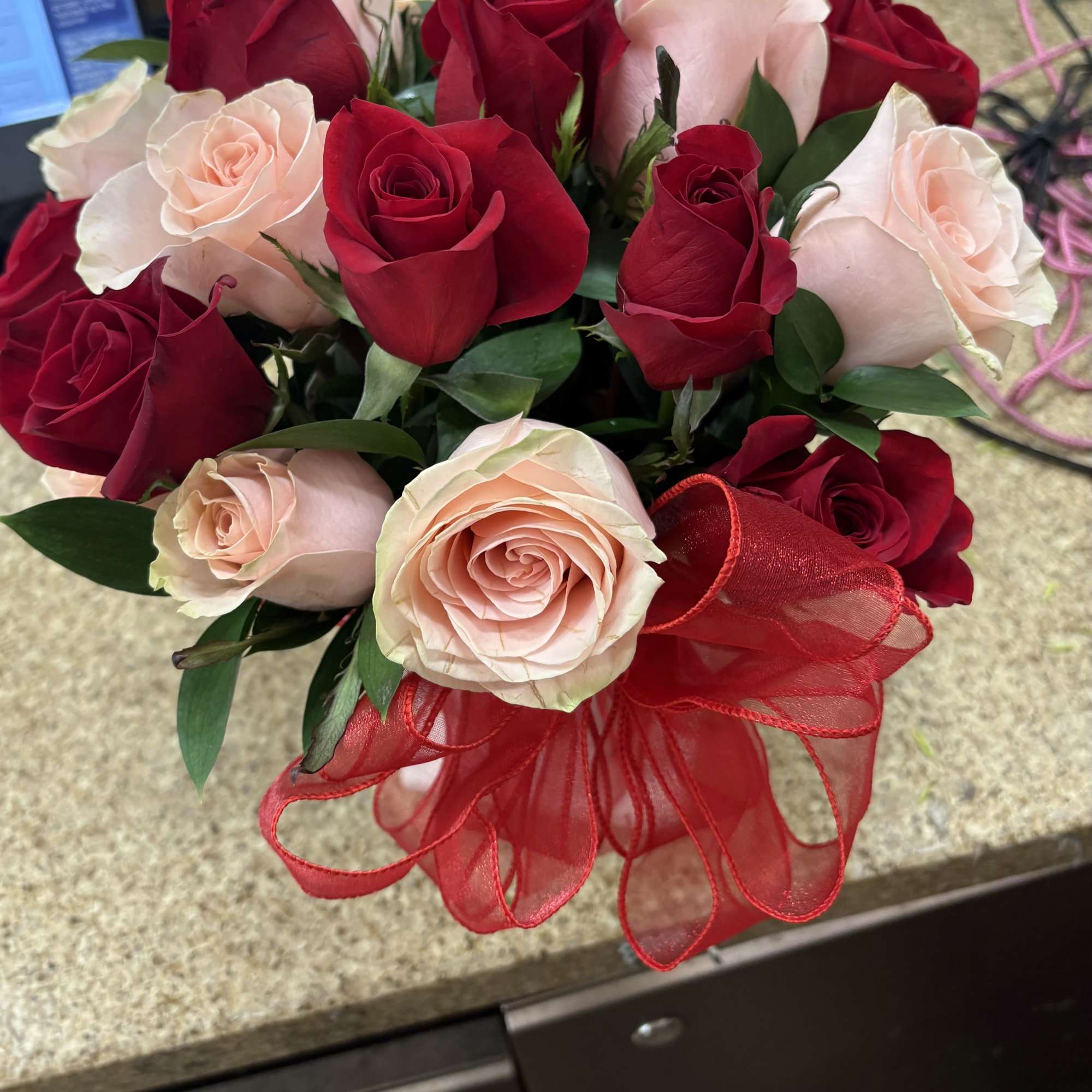 greenery with a dozen red and a dozen light pink or peach