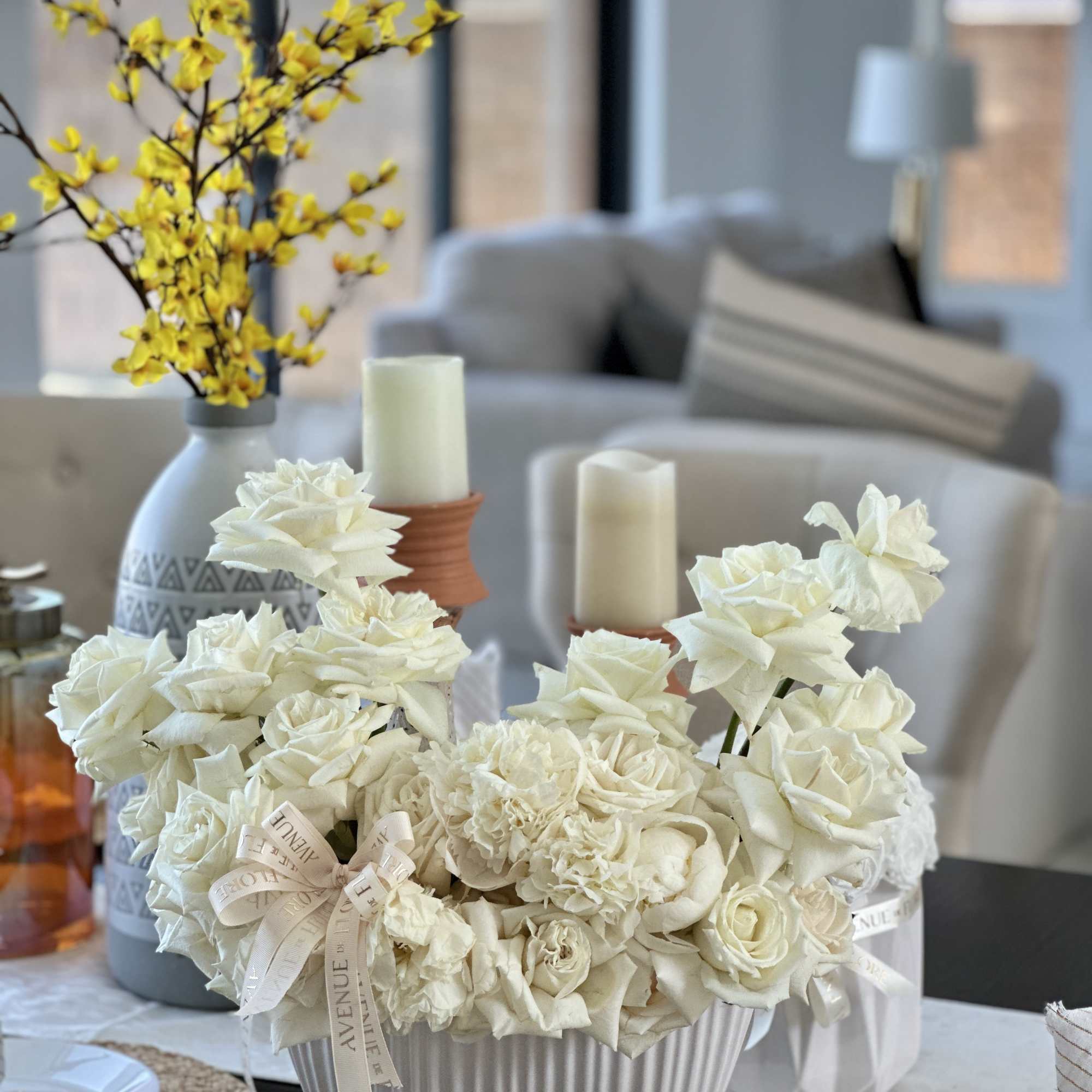 A sophisticated white rose arrangement nestled in a chic vase, perfectly balancing