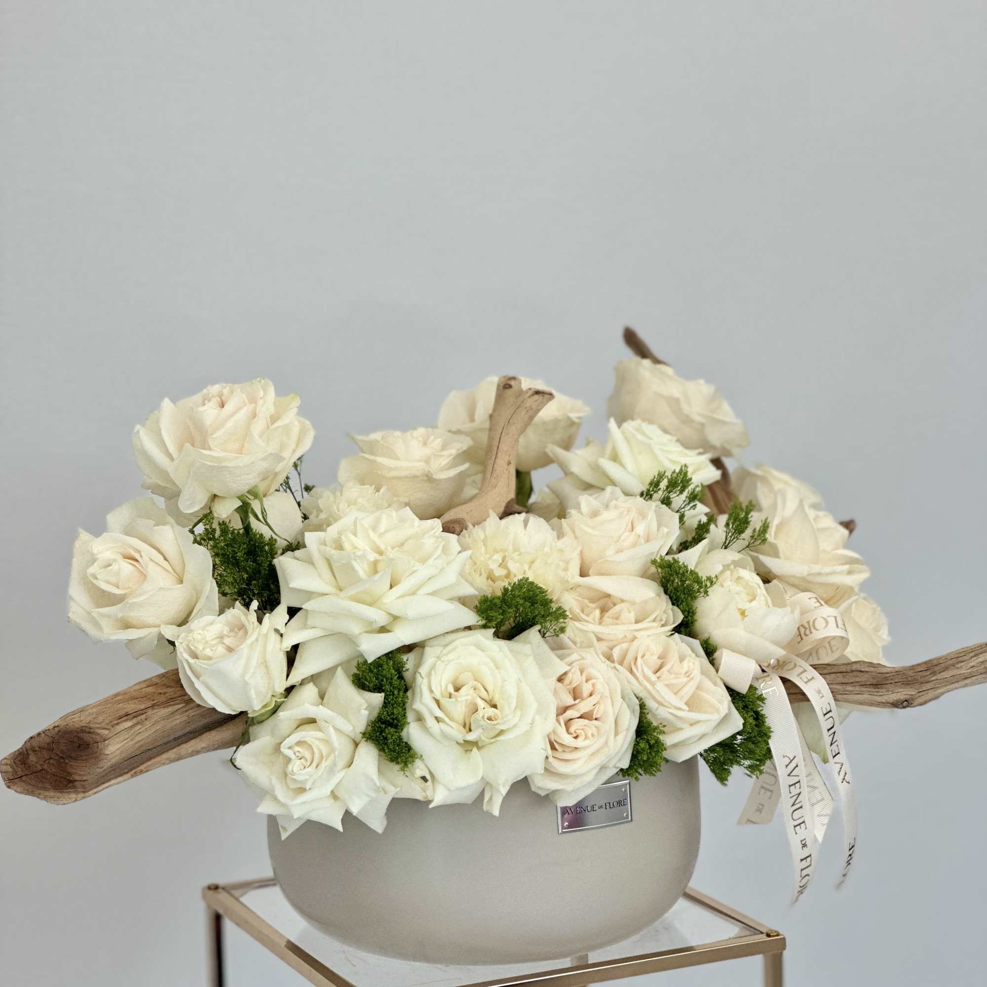 A serene and elegant arrangement delicately nestled in a sophisticated chic vase.