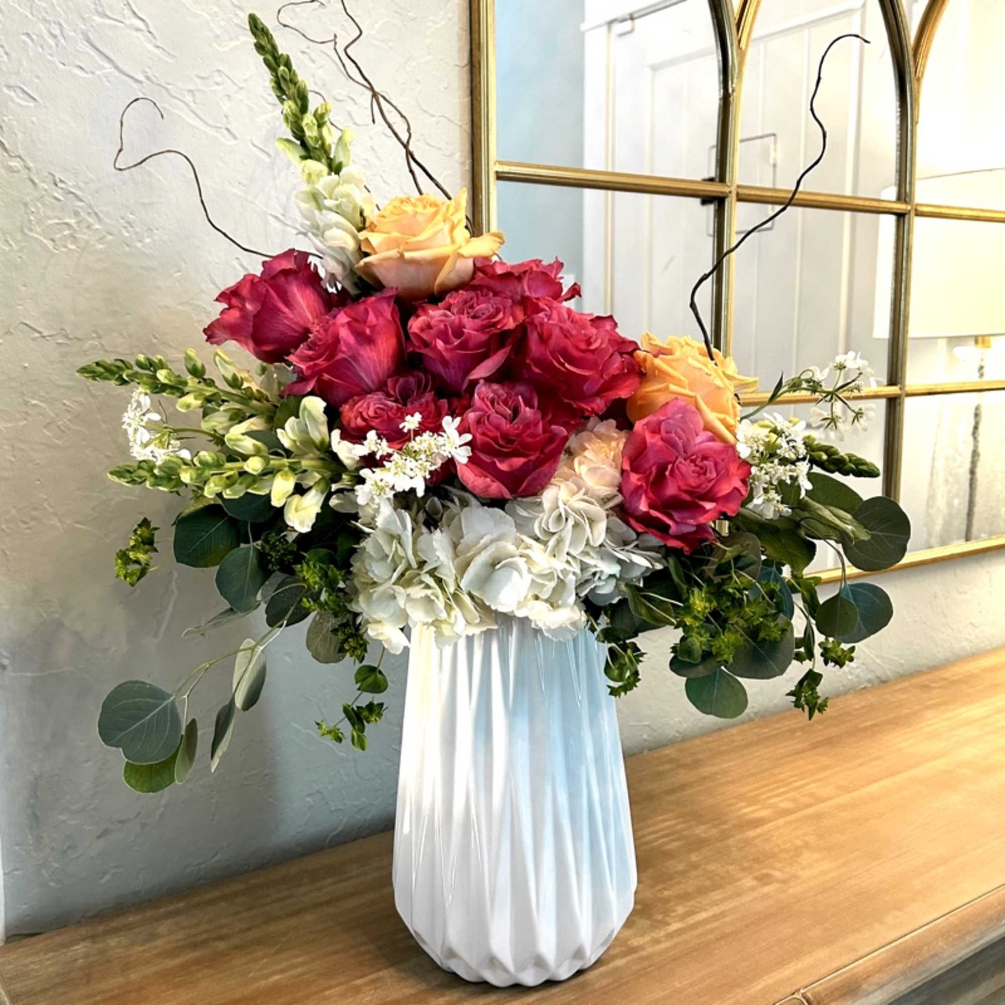 Faith Hope and Lovely consists of large seasonal roses, white hydrangea, chrysanthemums