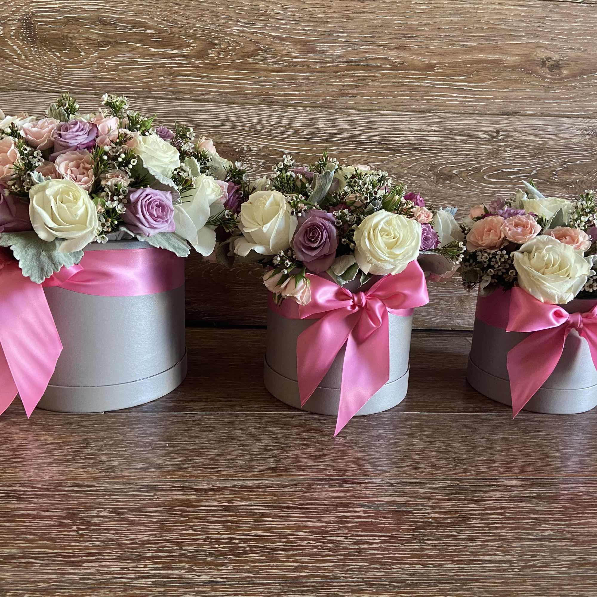 Gray Cylinder Box with Mix Pastel color Roses, and Pink Ribbon.