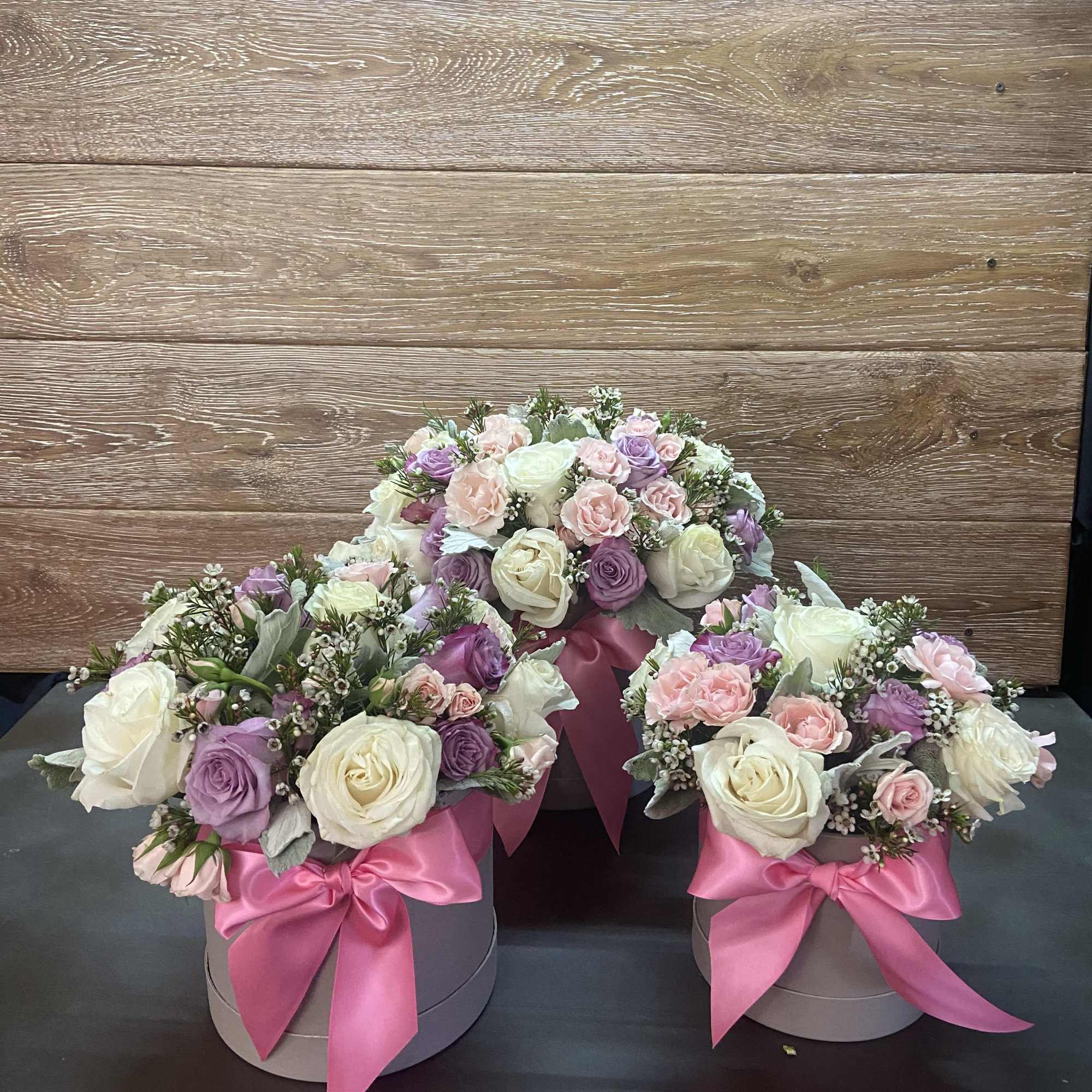 Gray Cylinder Box with Mix Pastel color Roses, and Pink Ribbon.