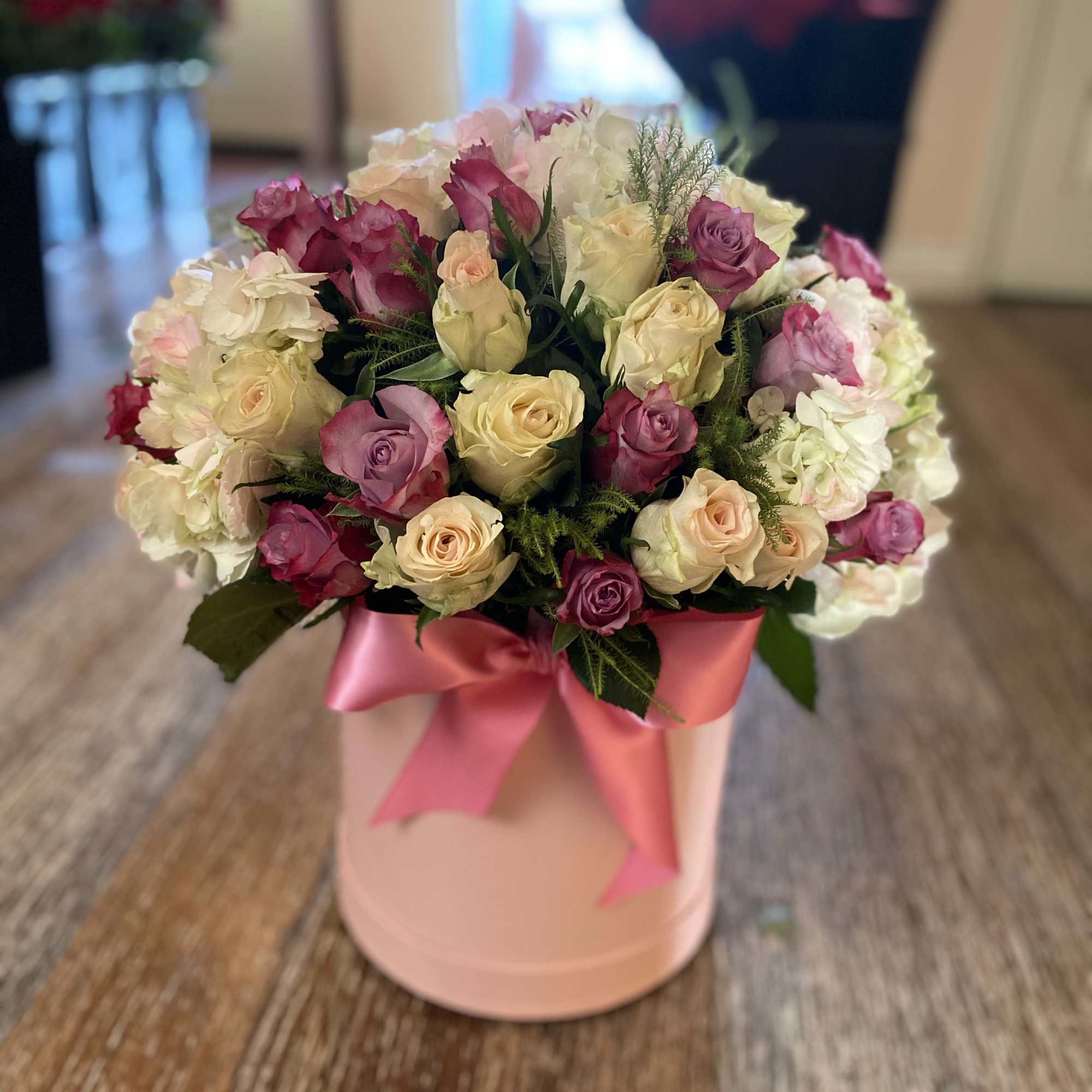 Cylinder Box with 12 Lavender, 12 Ivory Roses, and hydrangeas.