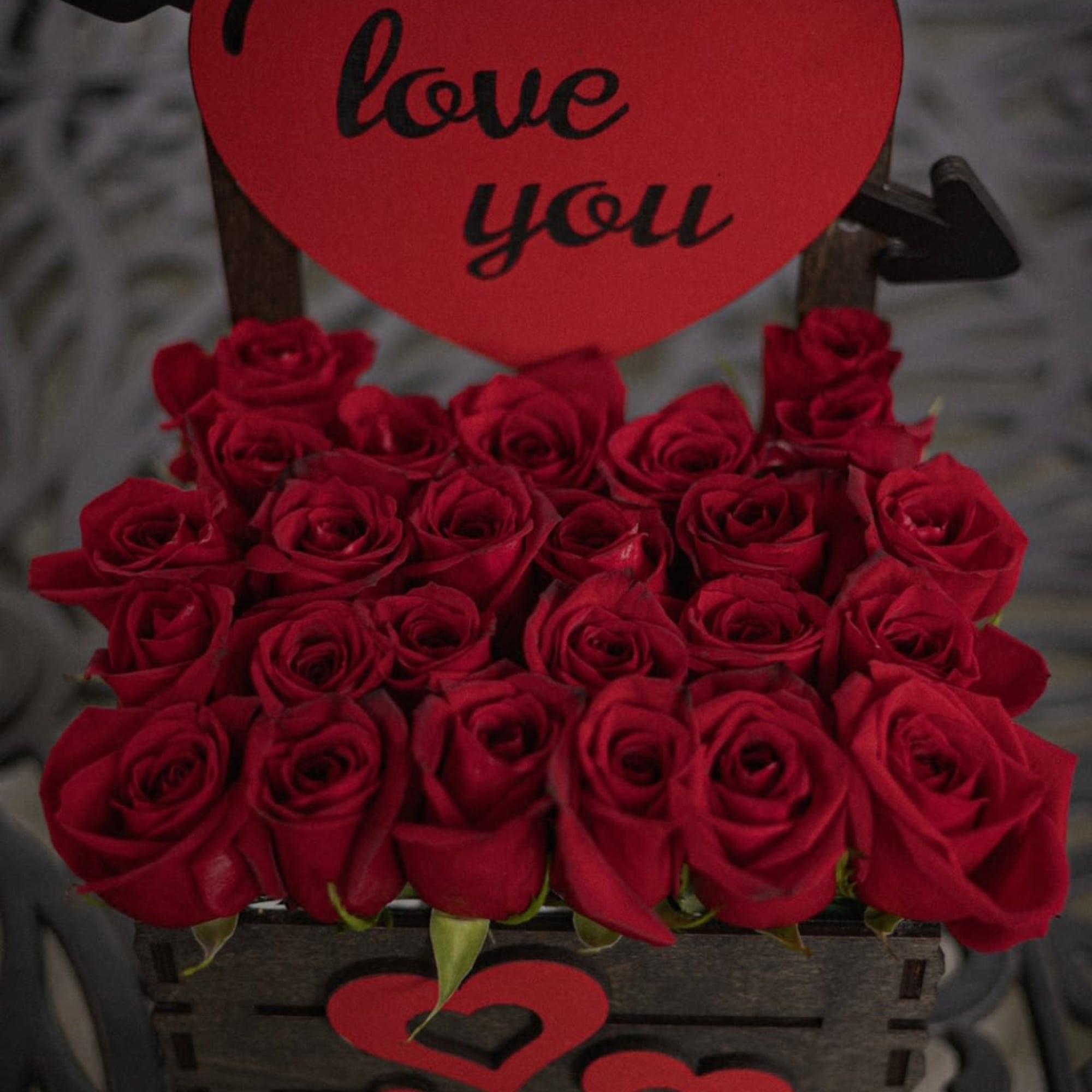 A Stunning arrangement of 24 roses, elegantly displayed with a &quot;LOVE YOU&quot;