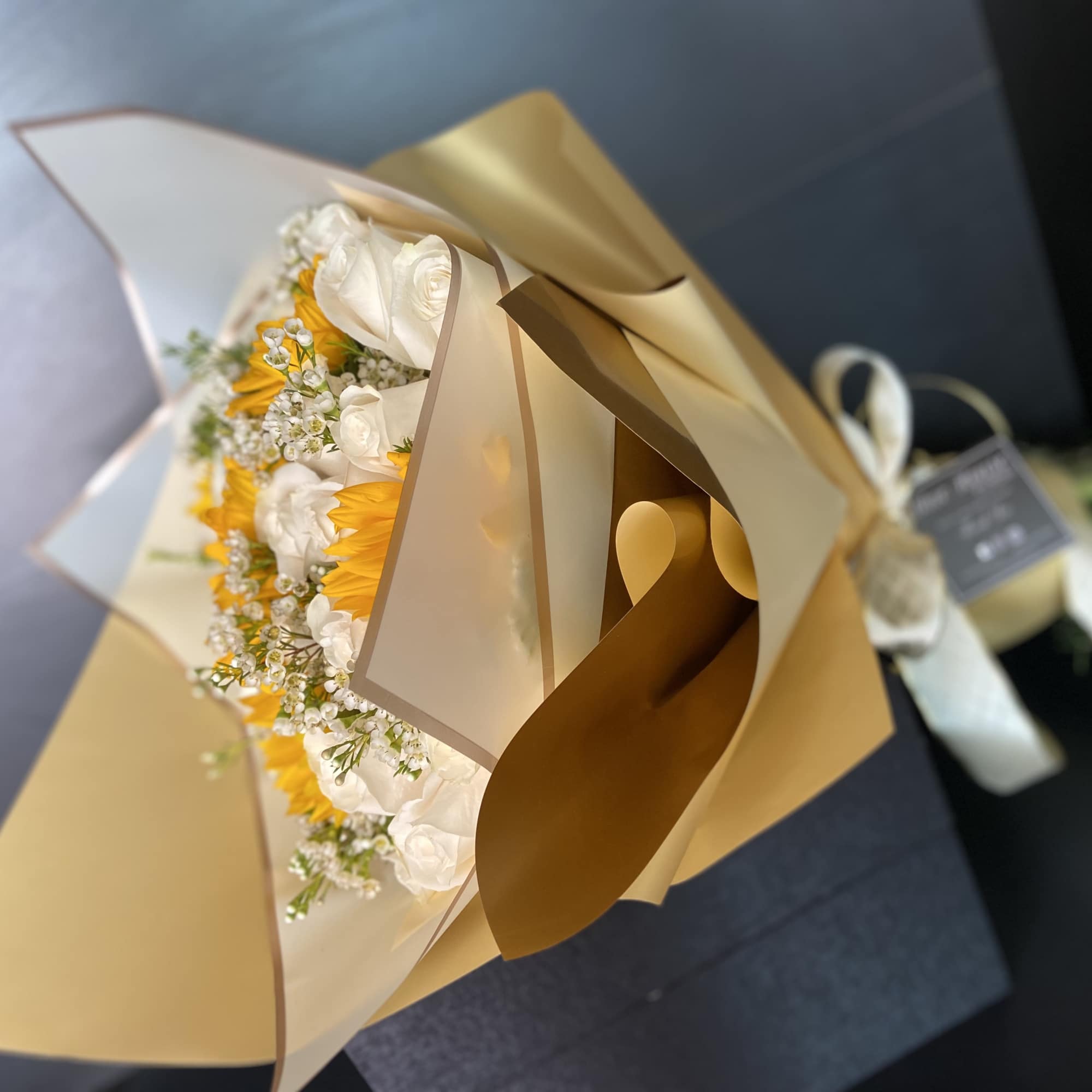 White Roses and Sunflowers wrapped with Gold and White Paper