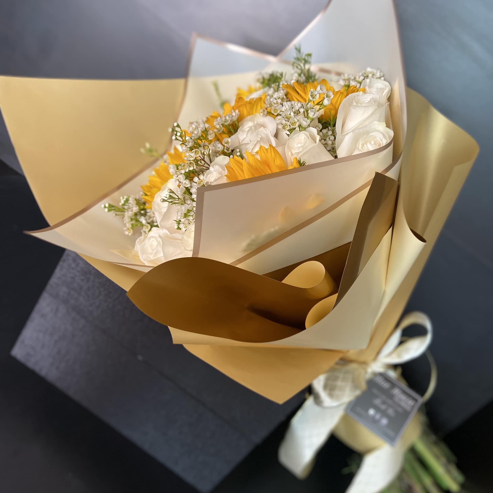 White Roses and Sunflowers wrapped with Gold and White Paper