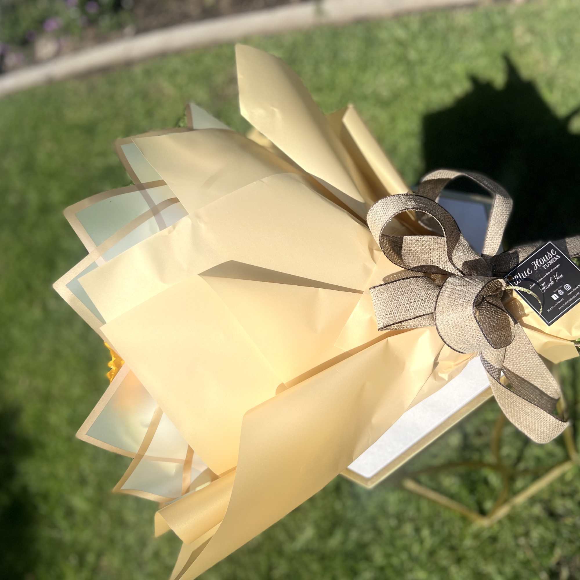 White Roses and Sunflowers wrapped with Gold and White Paper