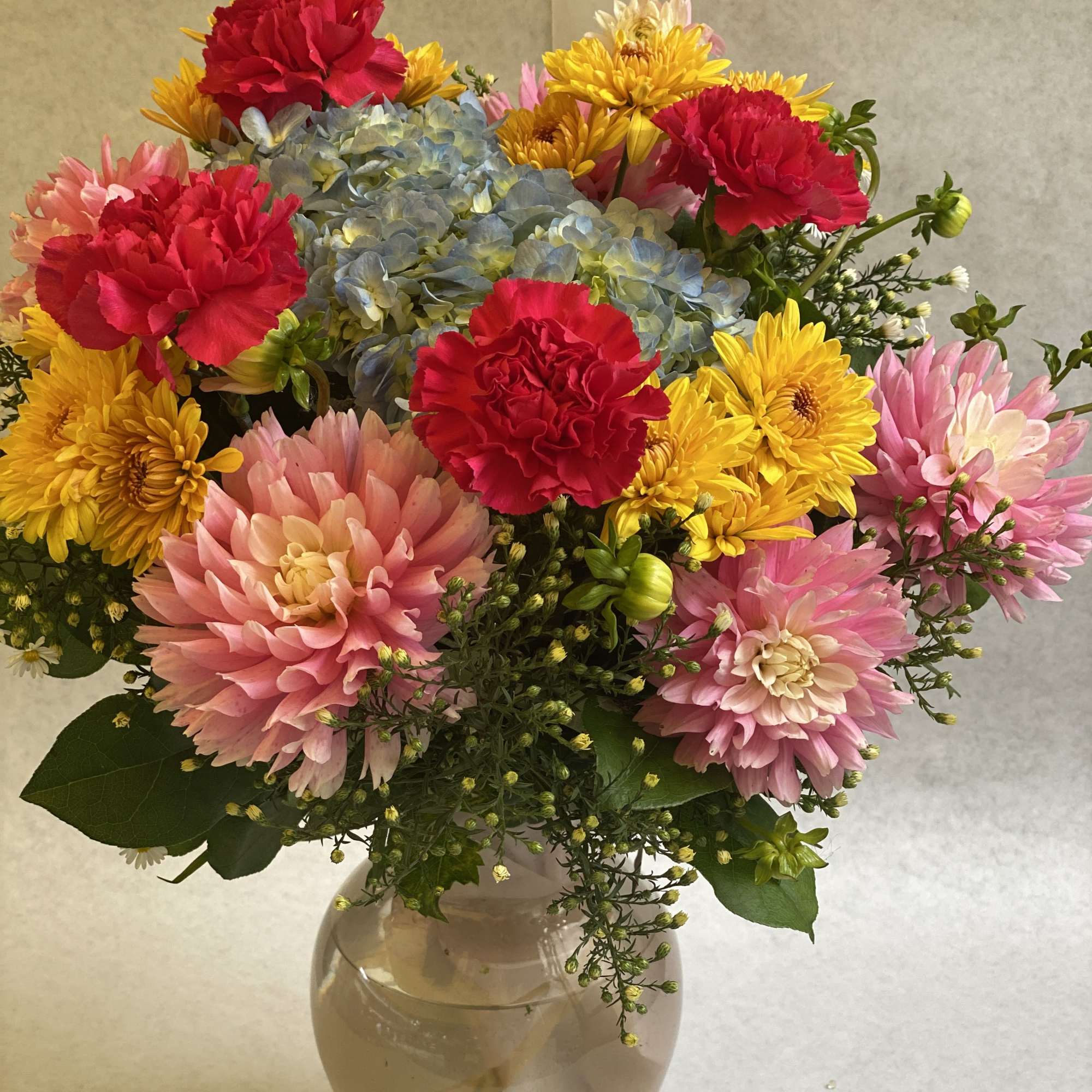An artistic and bright multi color arrangement is a pleaser and interesting