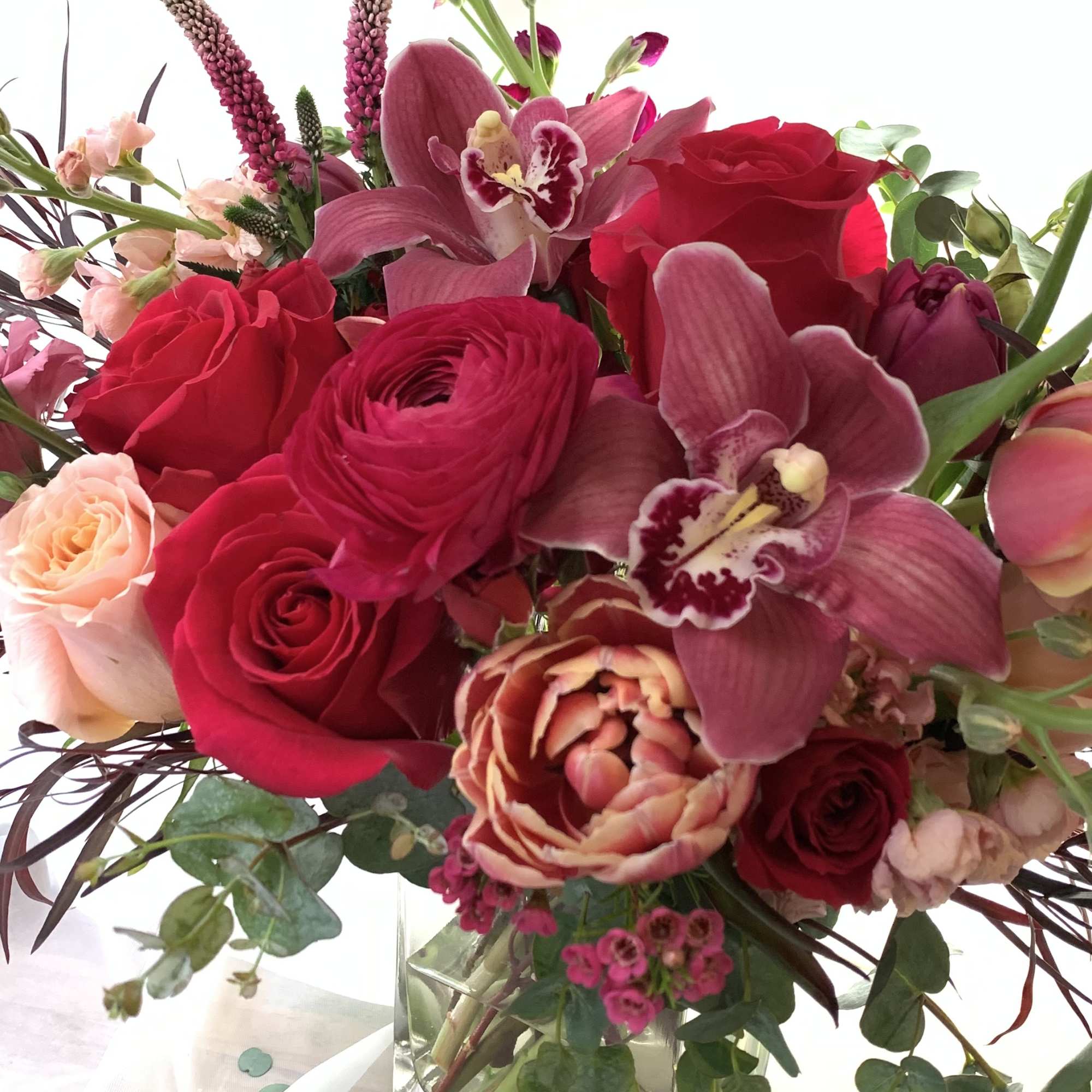 Hot pink roses with orchids and ranunculus. As Paris once said &quot;that&#039;s