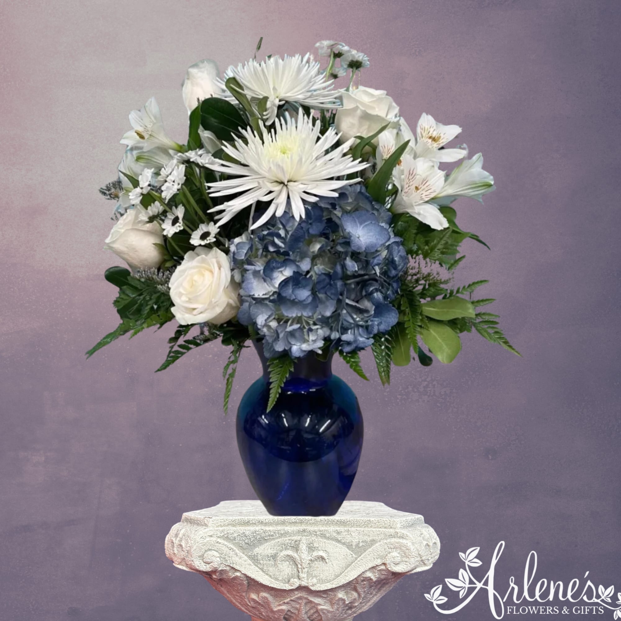 Chase away the blues with this white and blue frontal designed arrangement. Chase away the blues with this white and blue frontal designed arrangement.