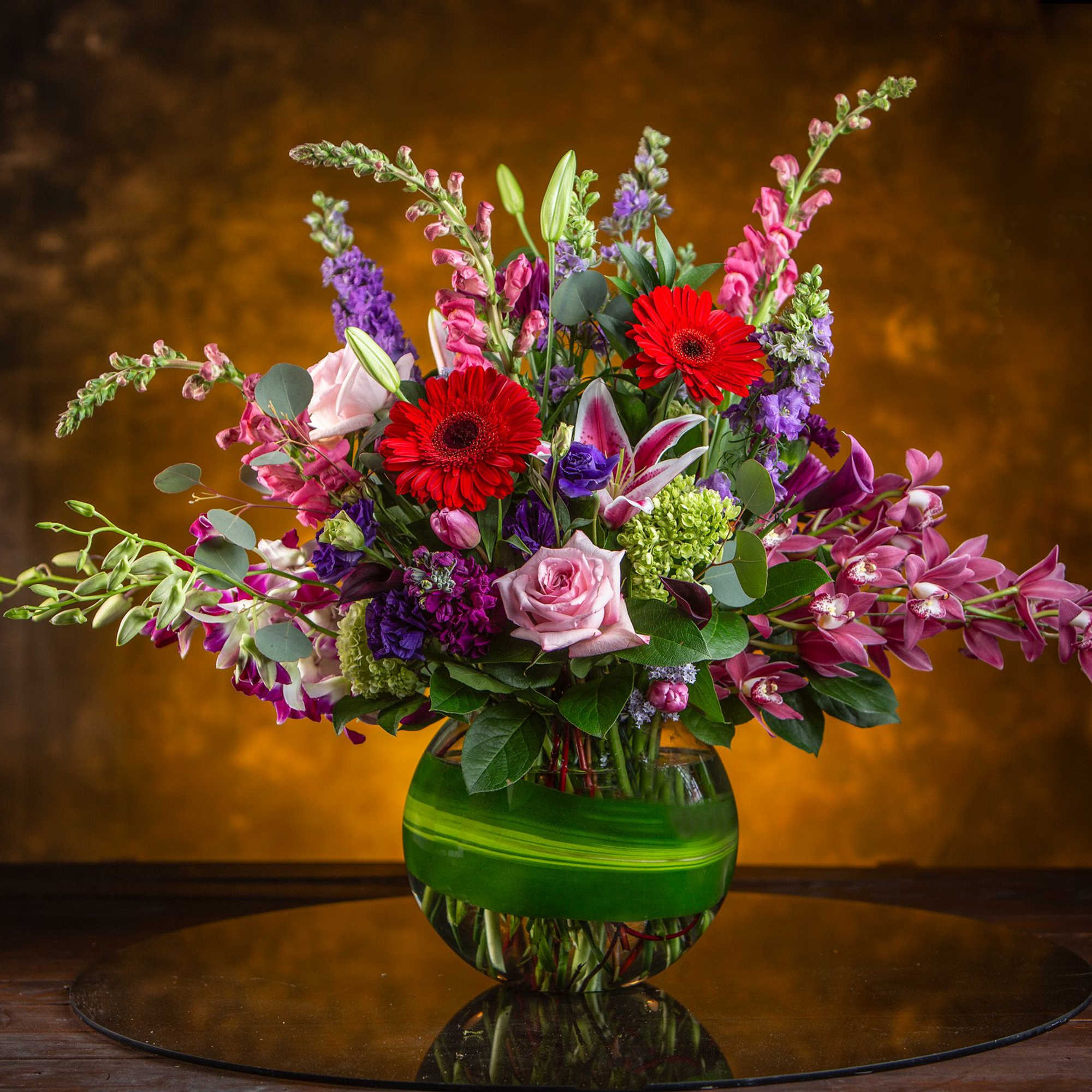 Send your love this exquisite design of pinks, purples, and reds. This