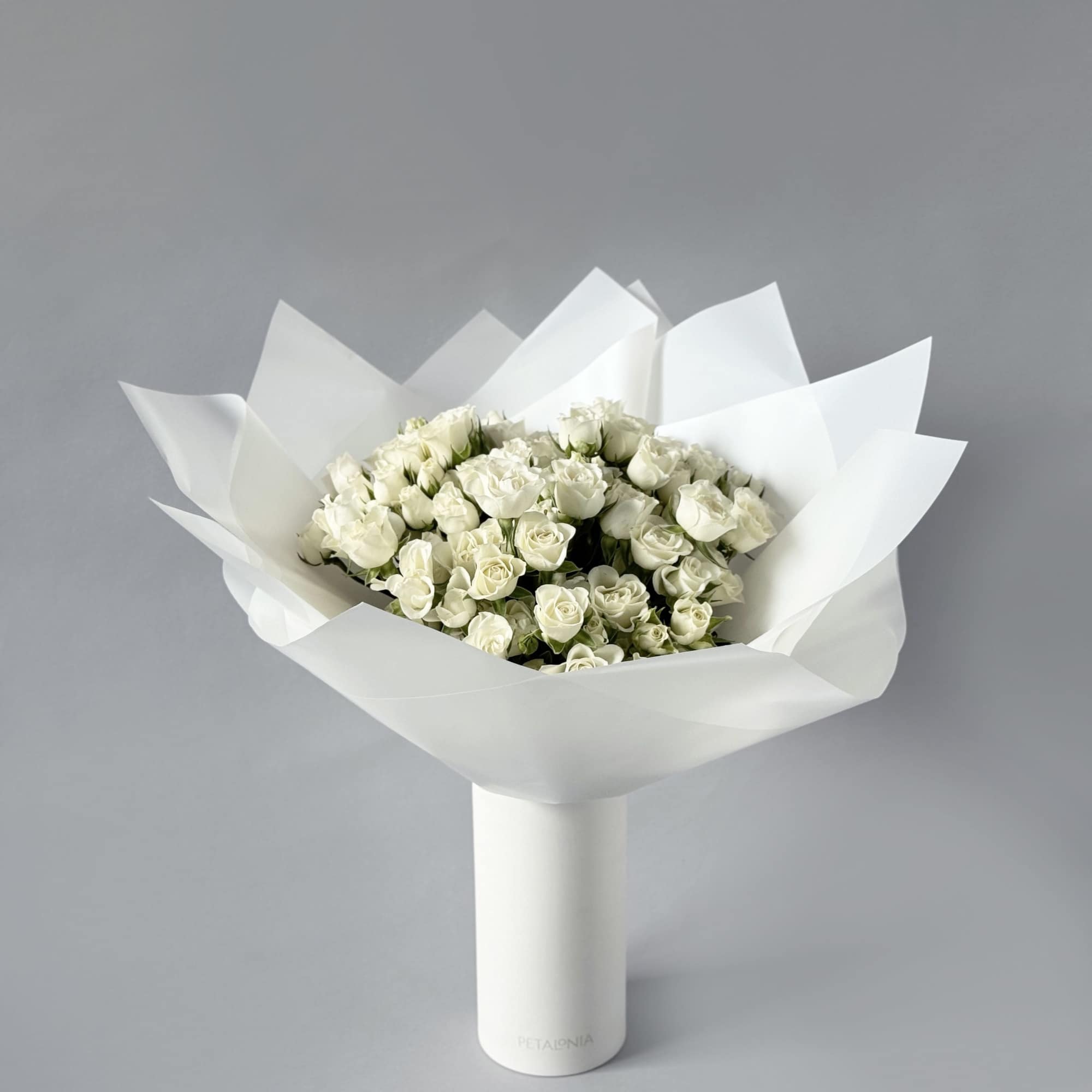 Experience timeless beauty with our preserved mini rose arrangement, elegantly displayed in