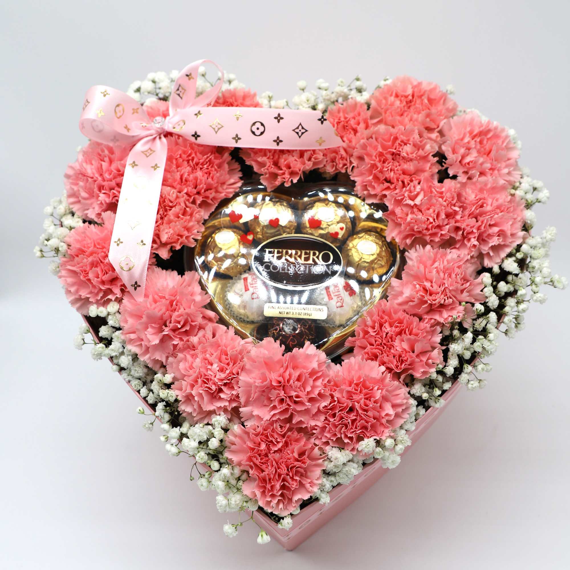 This box contains pink carnations and babys breath that is beautifully arranged